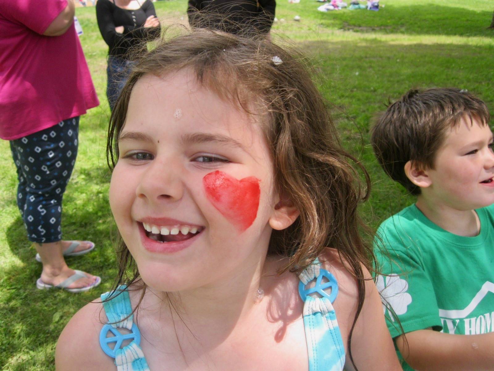 A student with a heart painted on cheeks.