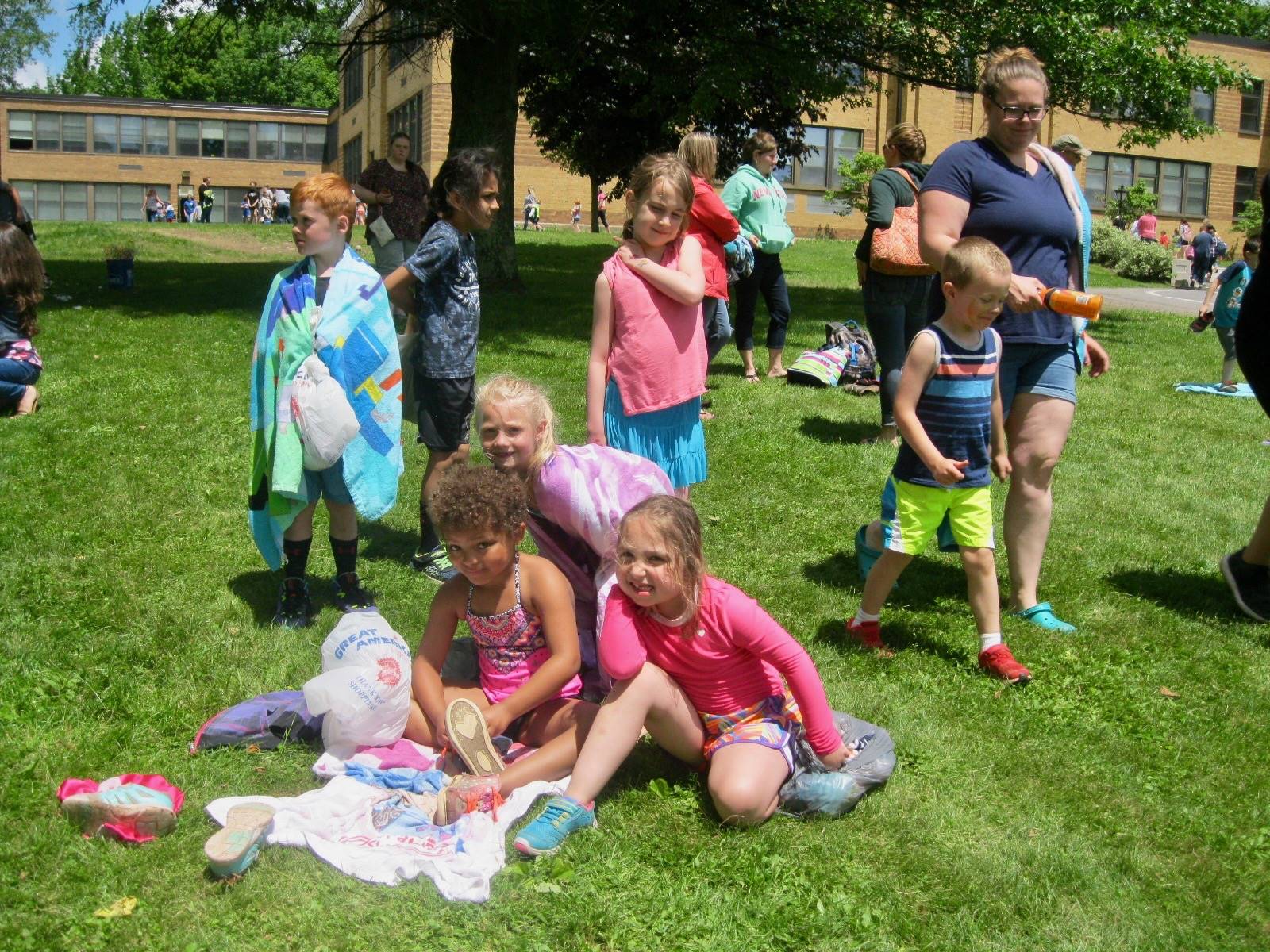 Students lounge on towels for a rest.