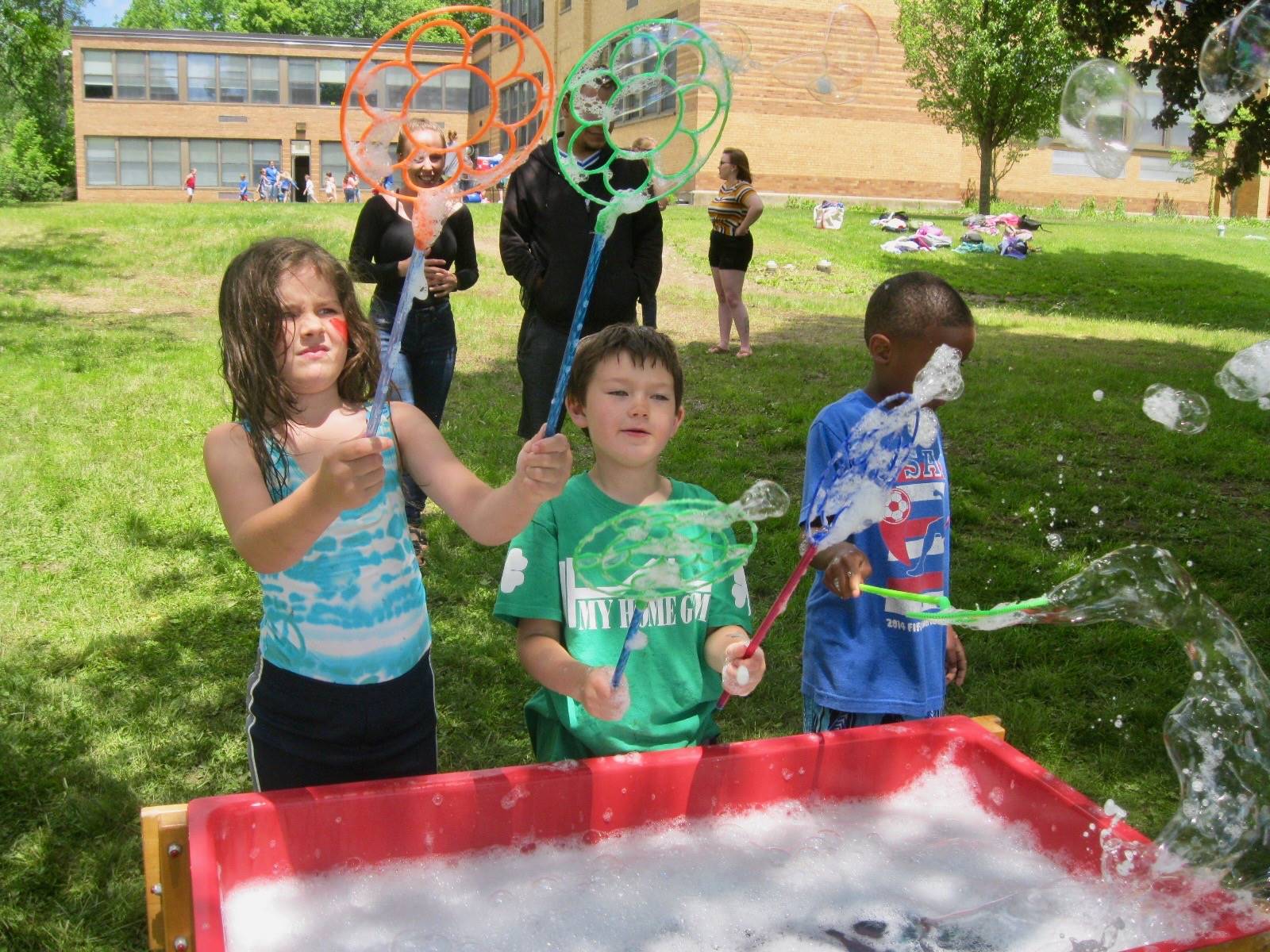 3 students with bubble wands.