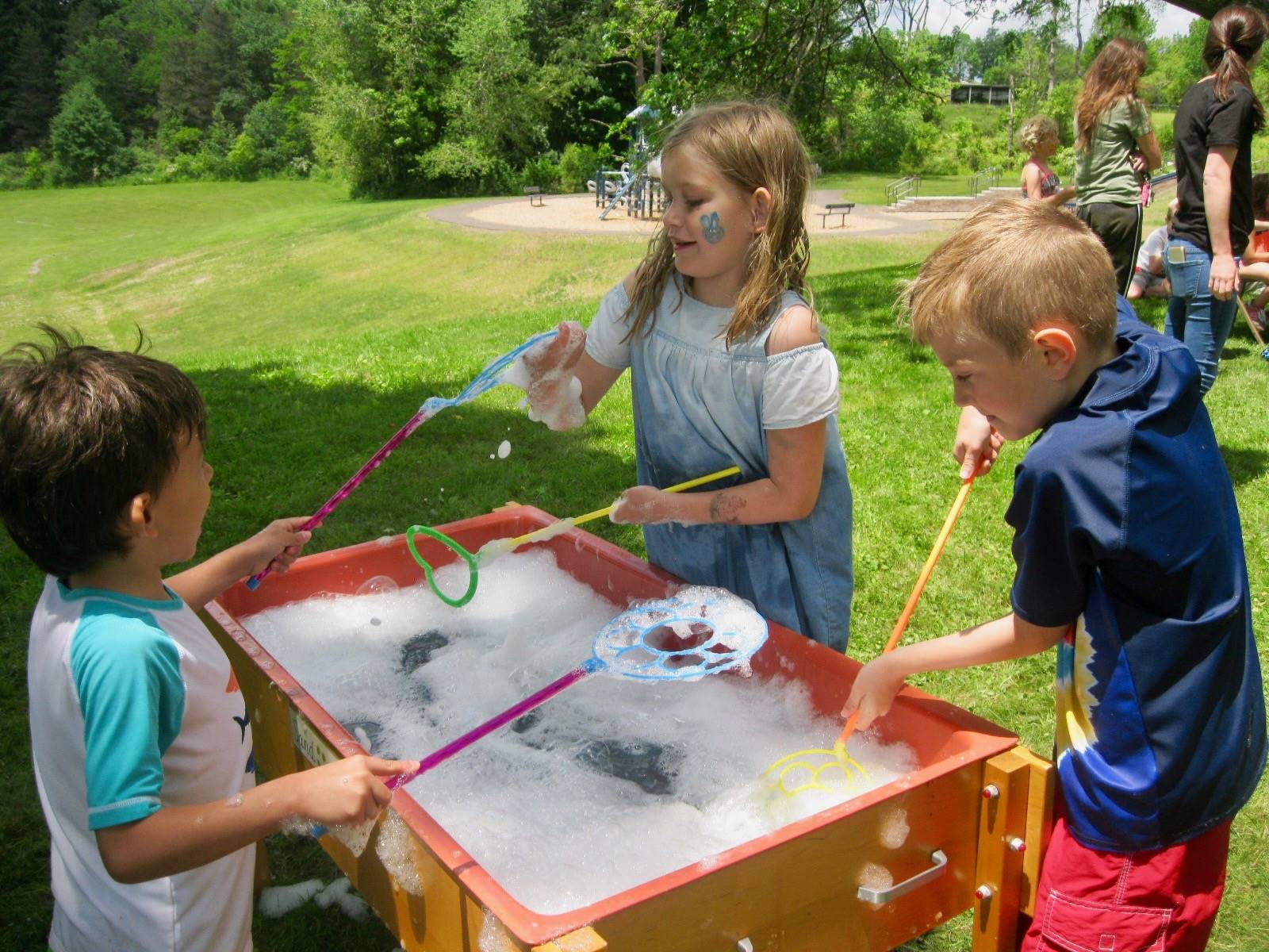 Students play with bubbles.