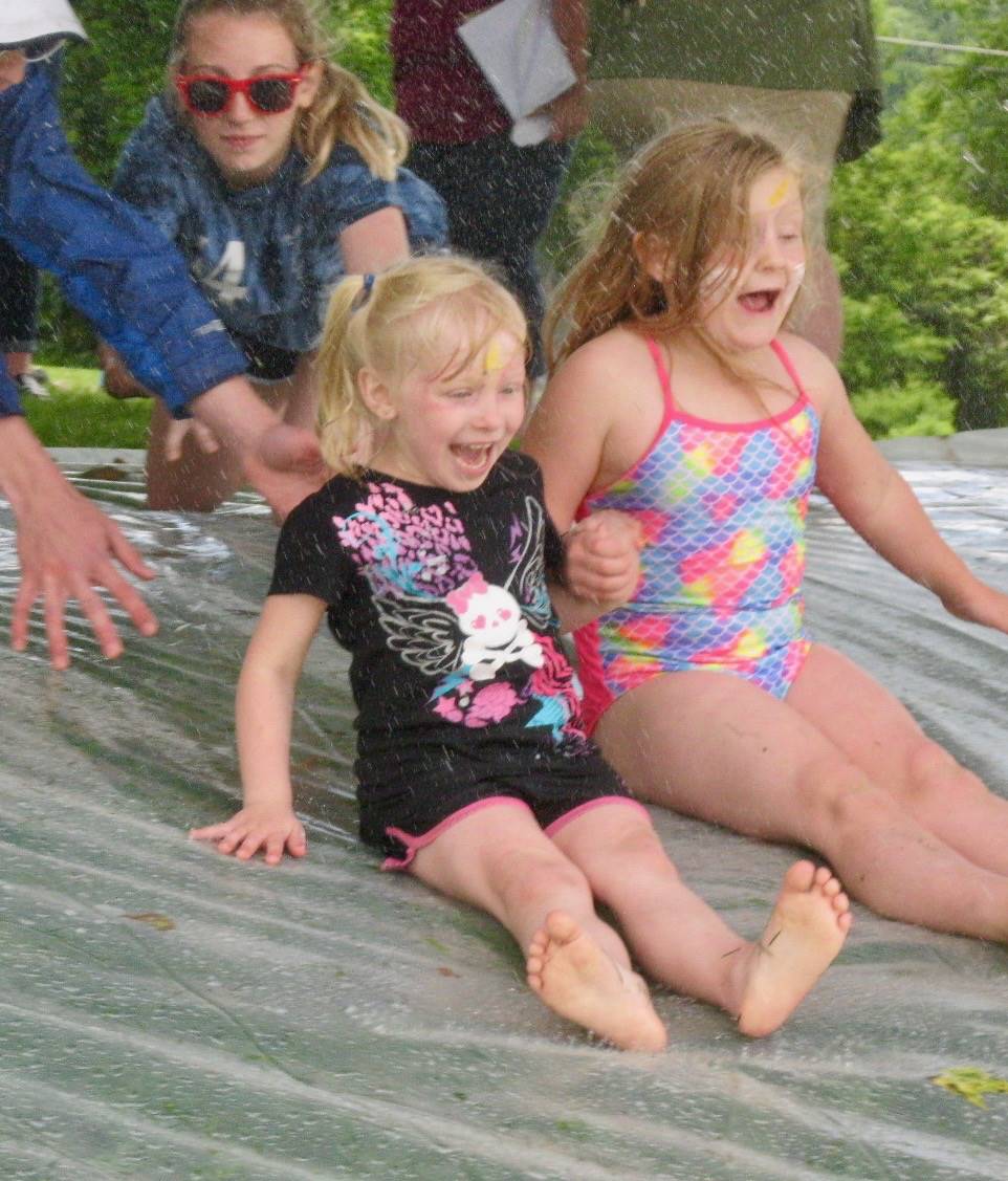 2 students on water slide.