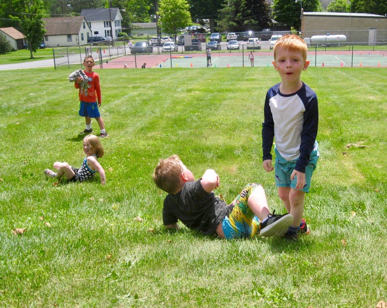 4 students roll down hill.