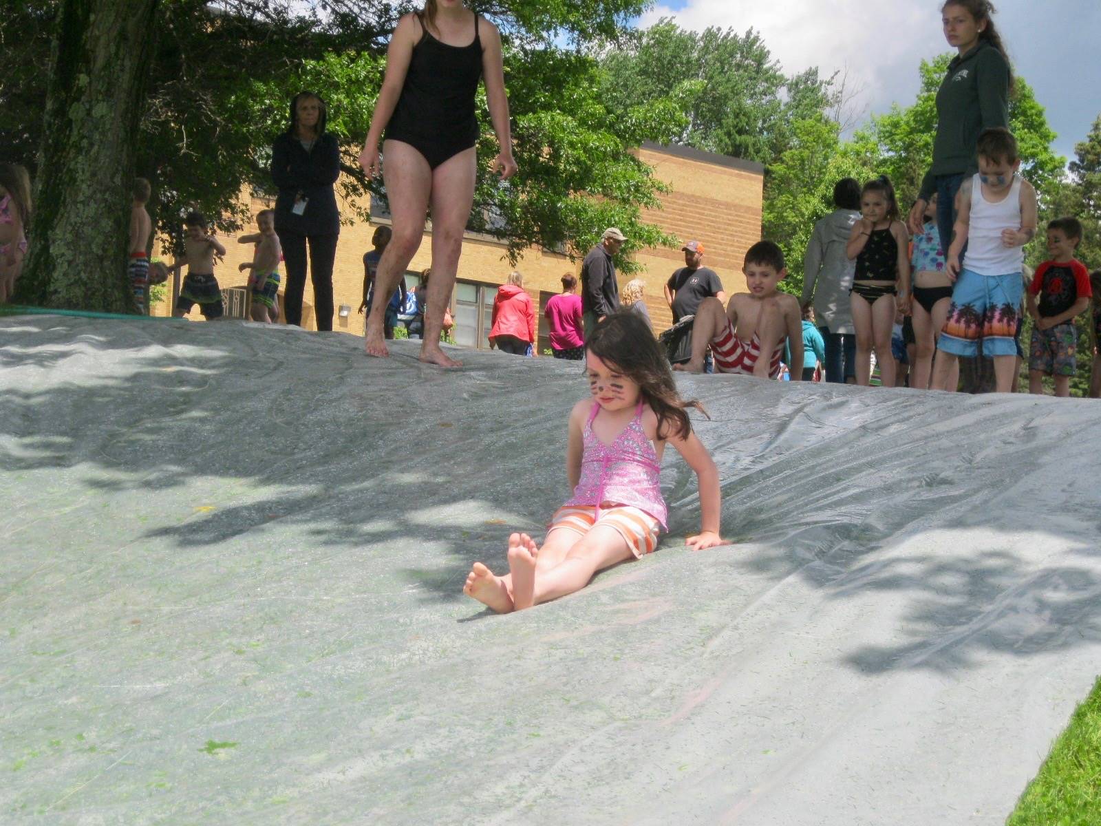 a student goes down water slide.