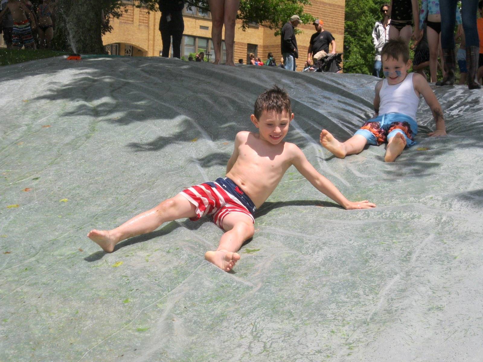 2 students go down water slide.