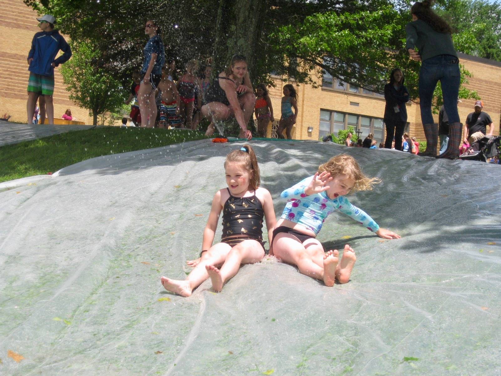 2 students go down water slide.