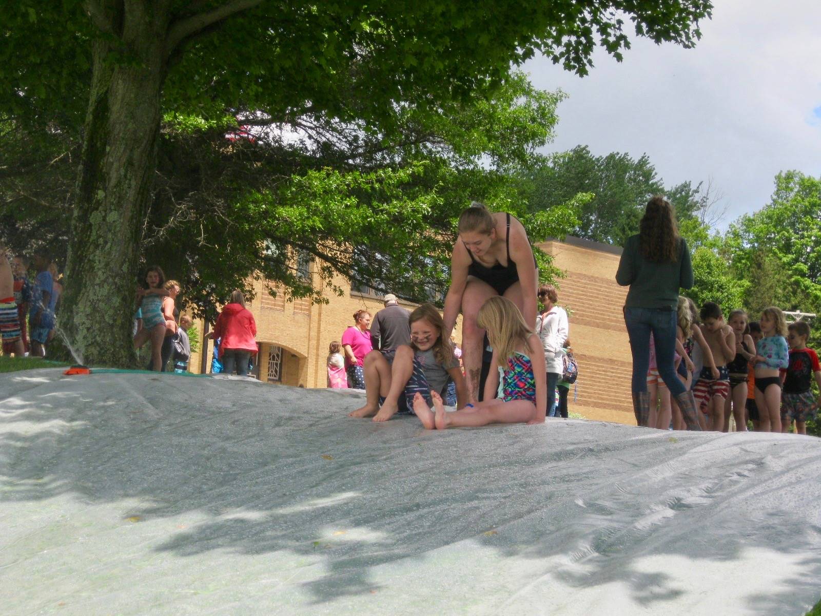 2 students get pushed down slide.