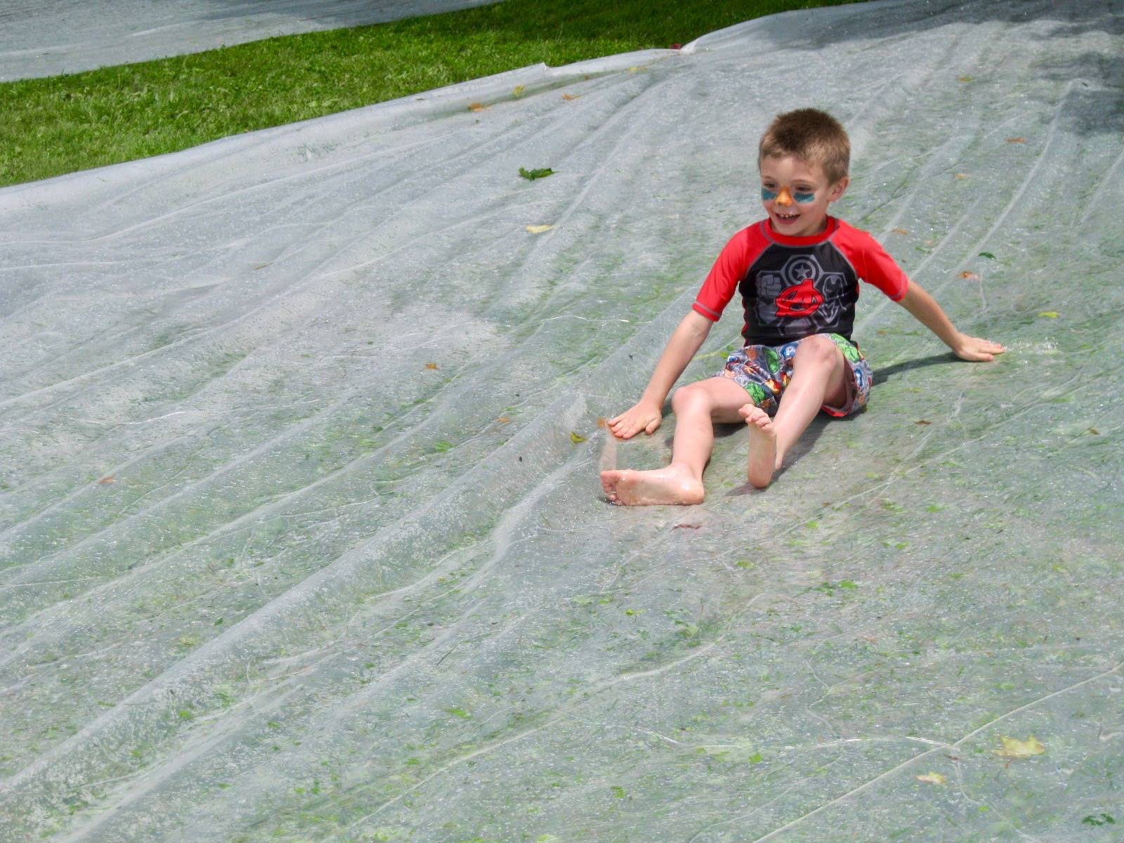 a students goes down water slide.