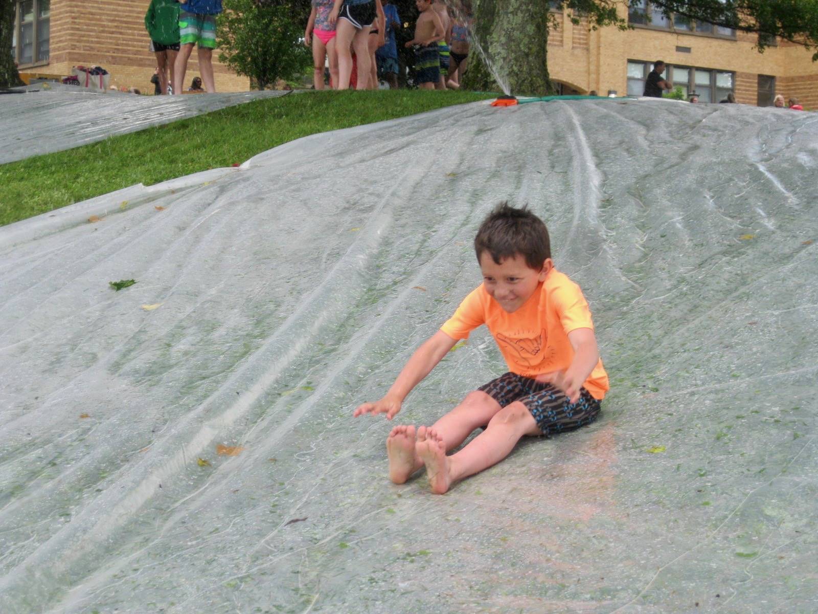 a student goes down water slide.