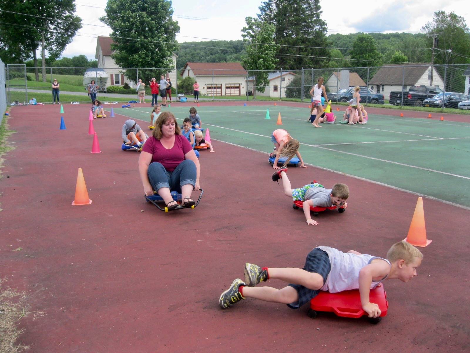 A teacher and students race on scooters!