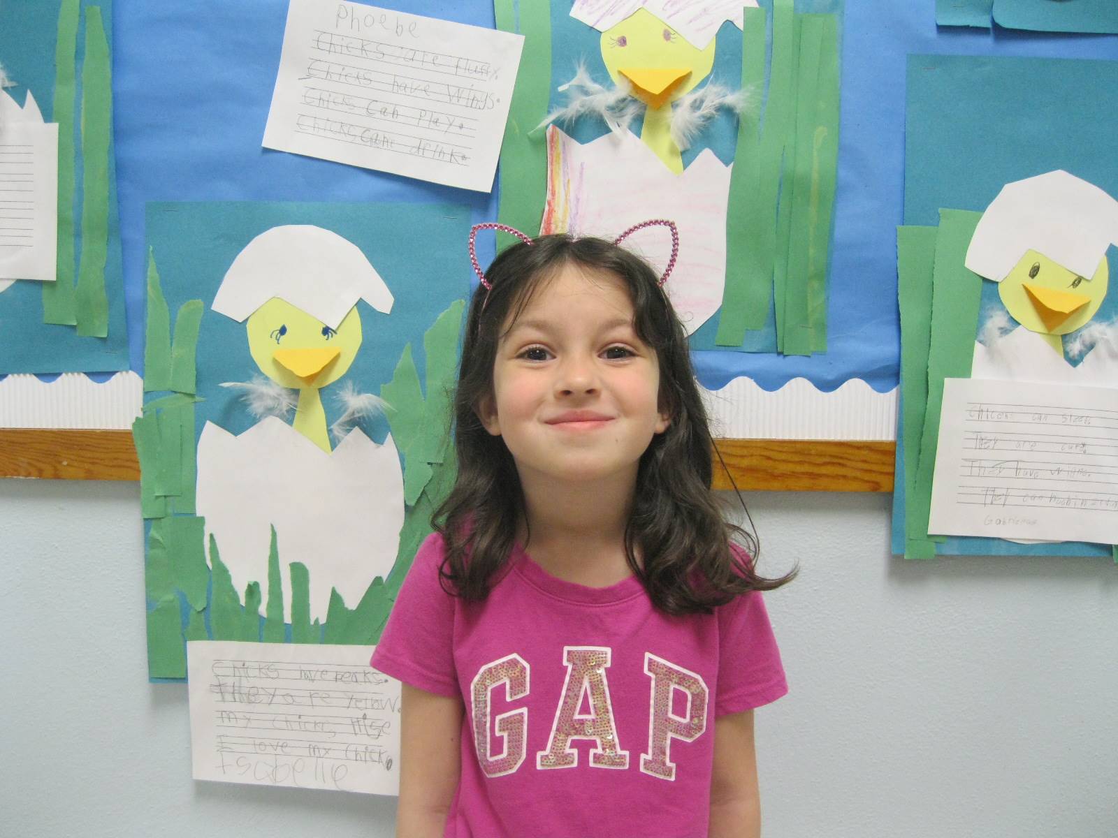 1 student by the bulletin board of chicks.