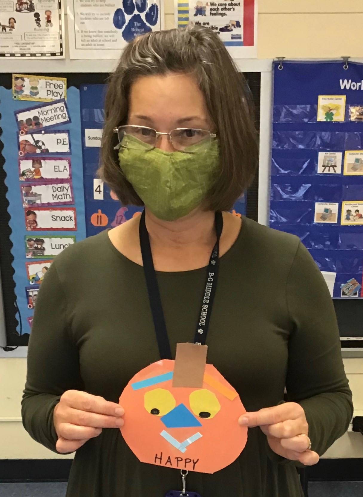 Staff member holds a pumpkin emotion.