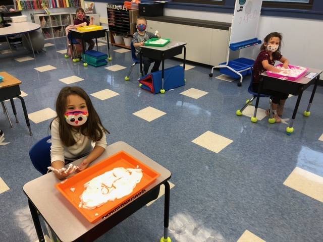 2 student write in shaving cream!