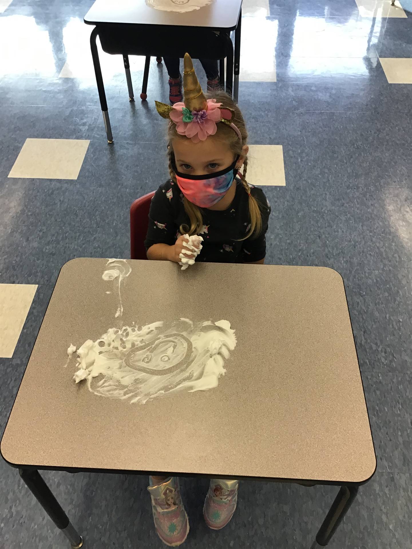 student draws an emotions in  shaving cream!