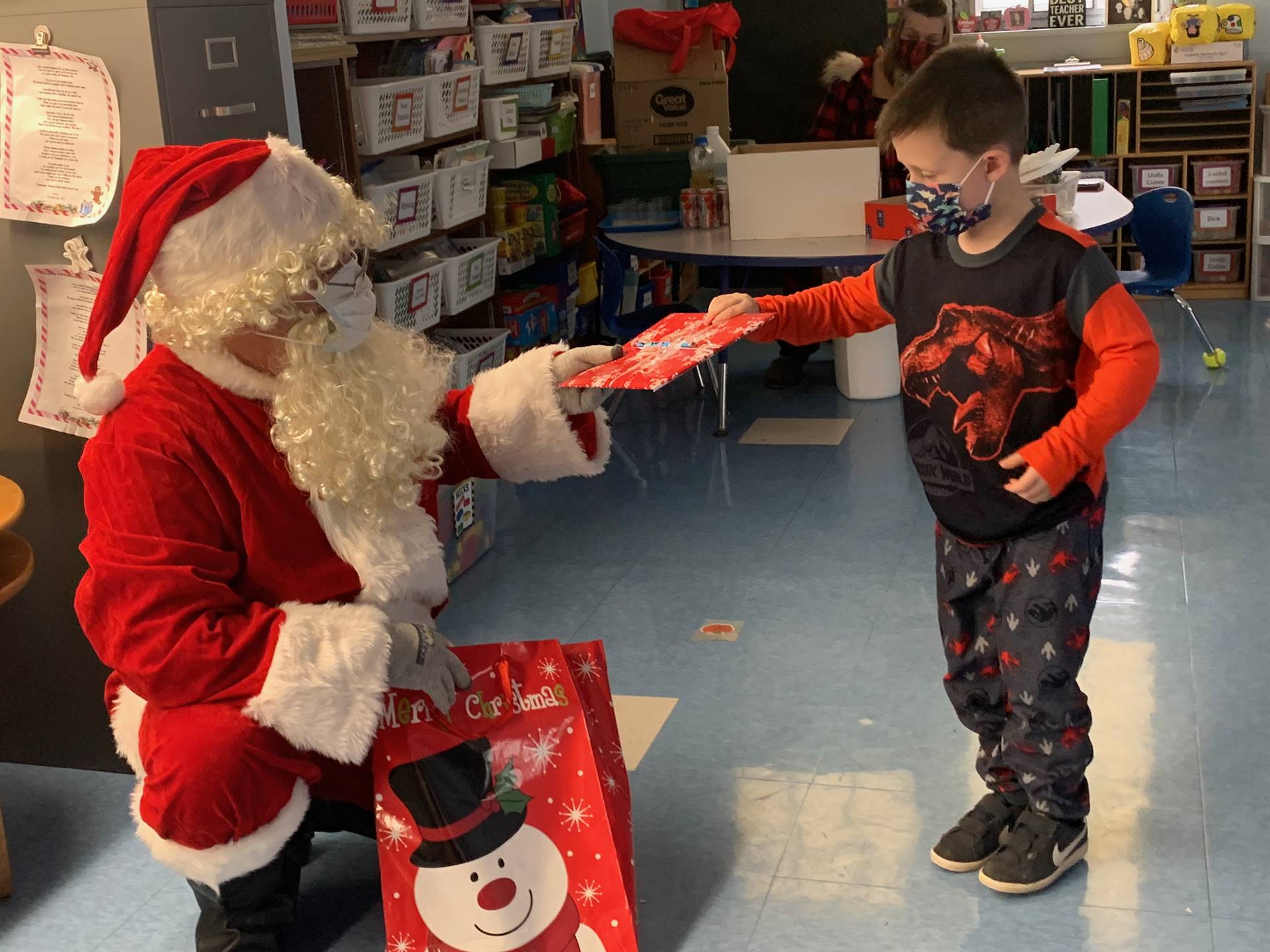 A student accepts a gift from Santa