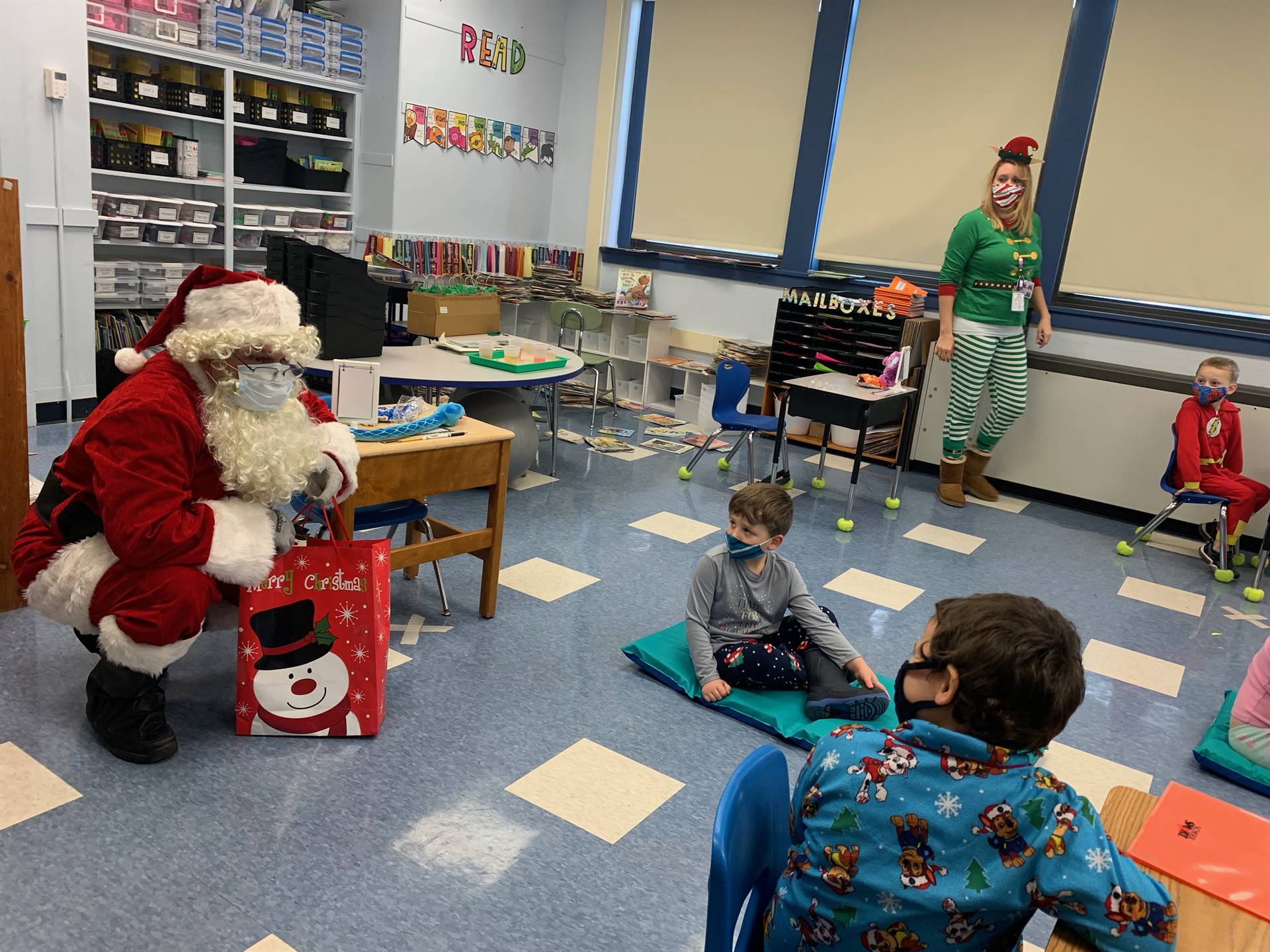 Santa talks to a class of students. 