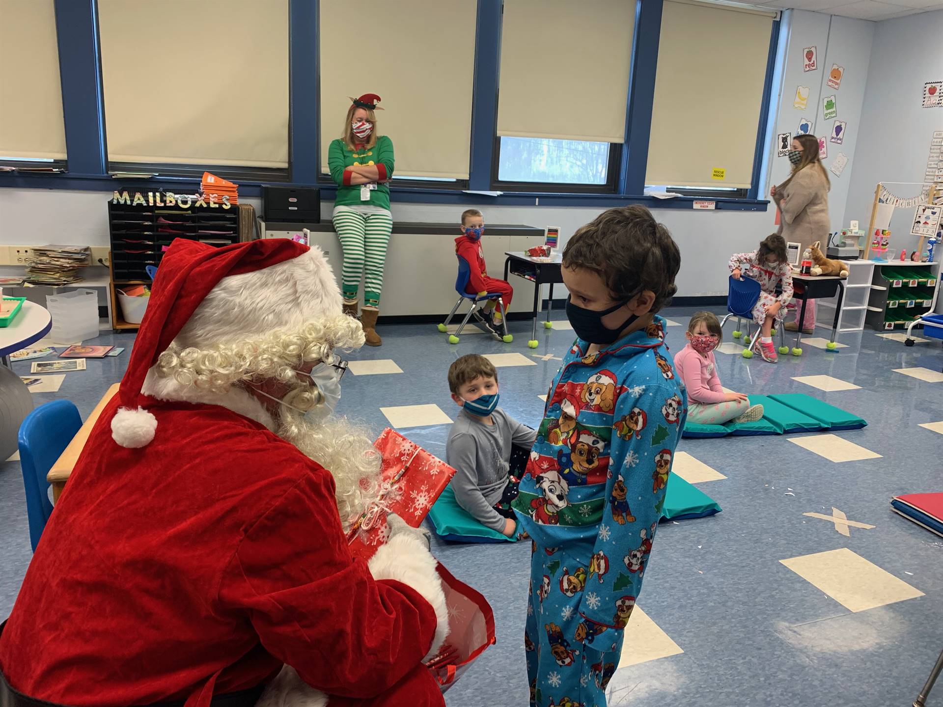 A student accepts a gift from Santa.