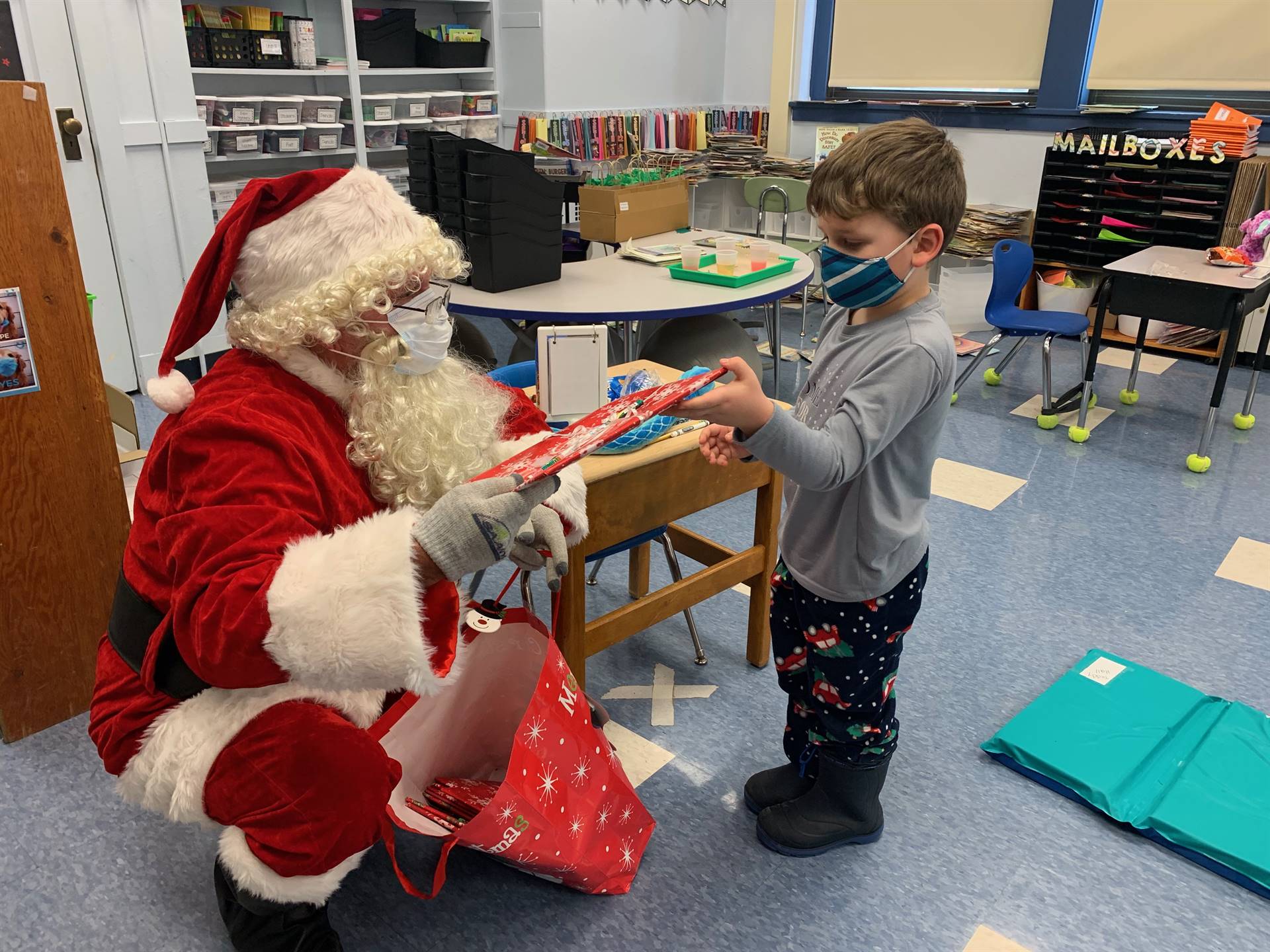A student accepts a gift from Santa!