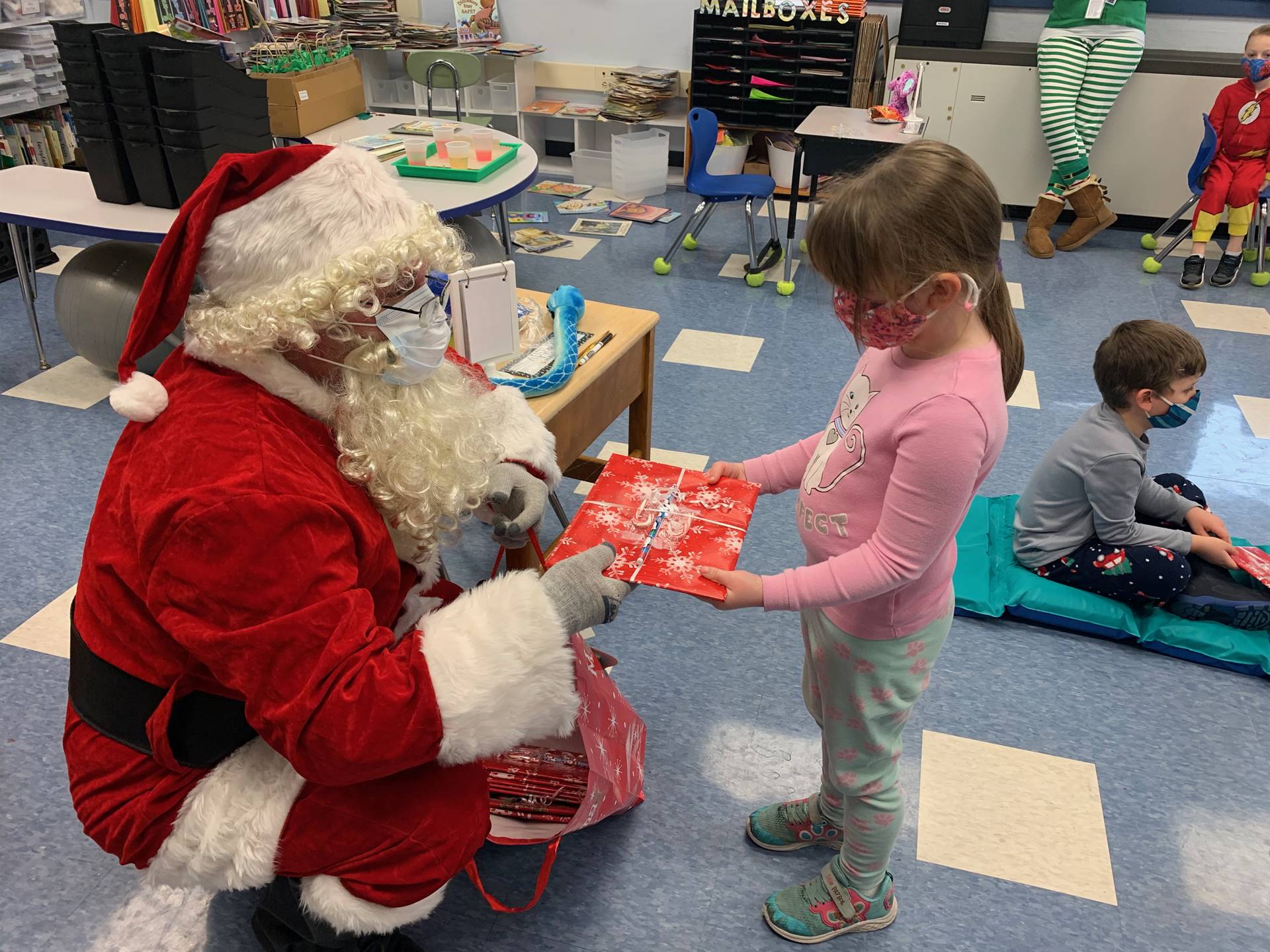 Santa and a student talk.