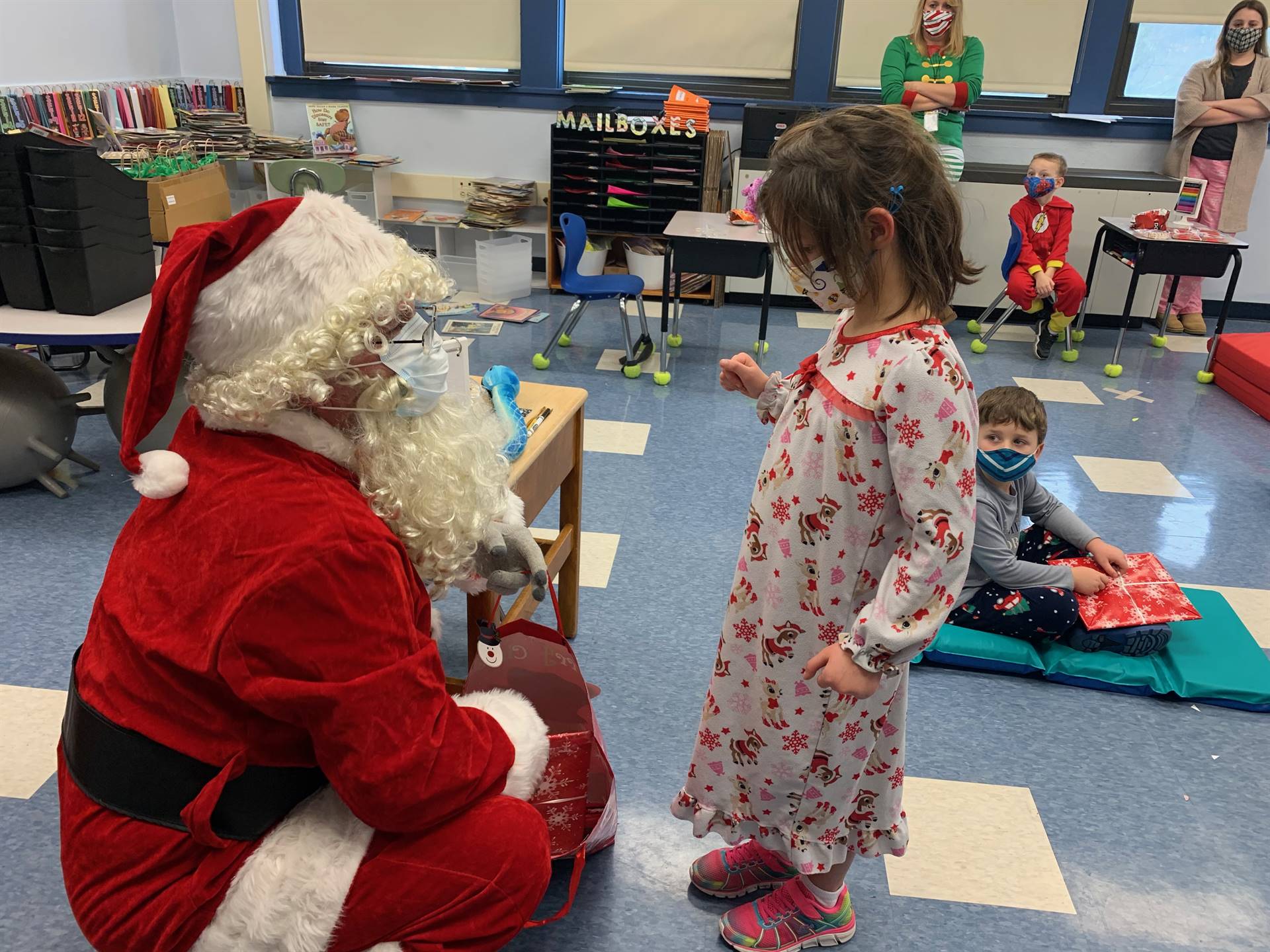 Santa asks a girl if she has been good.