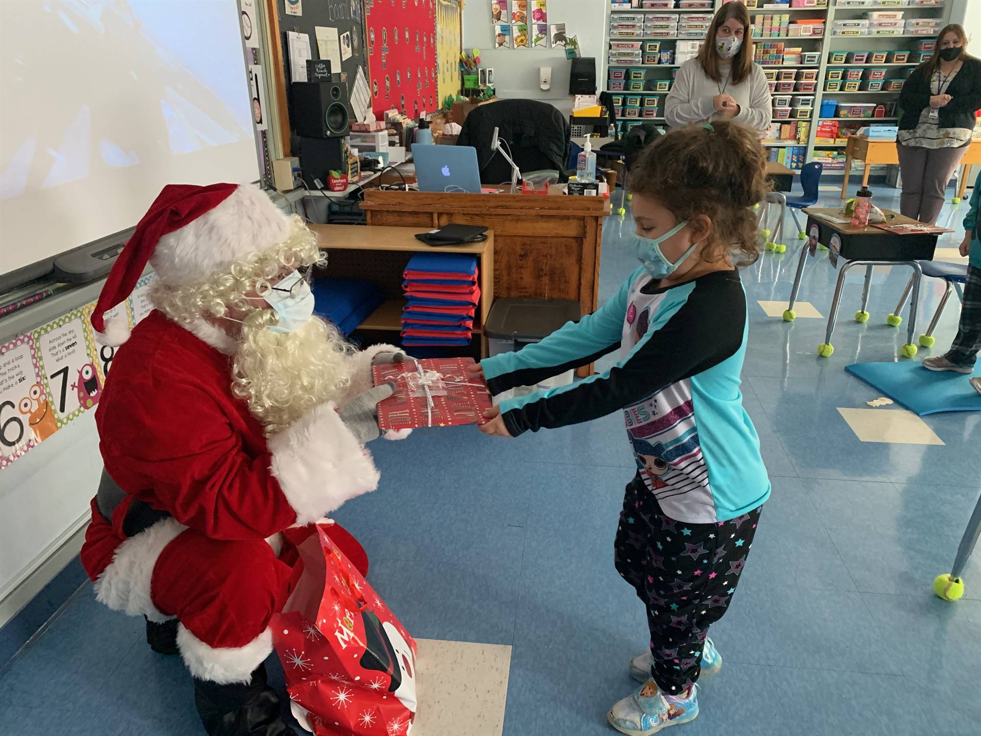 A students takes a gift from Santa.