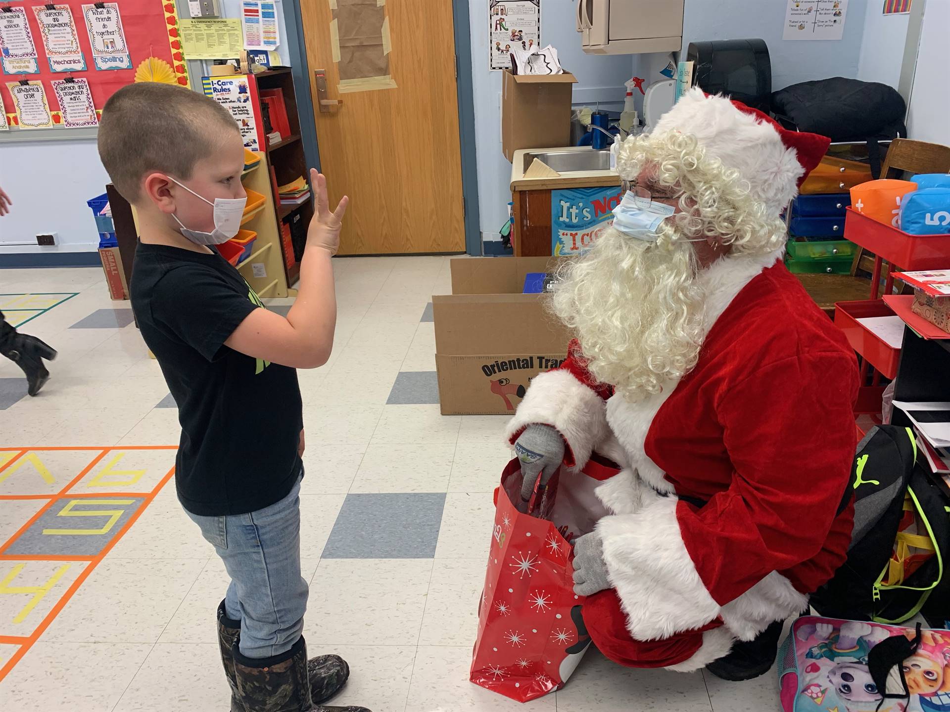 A student shows Santa how old he is.