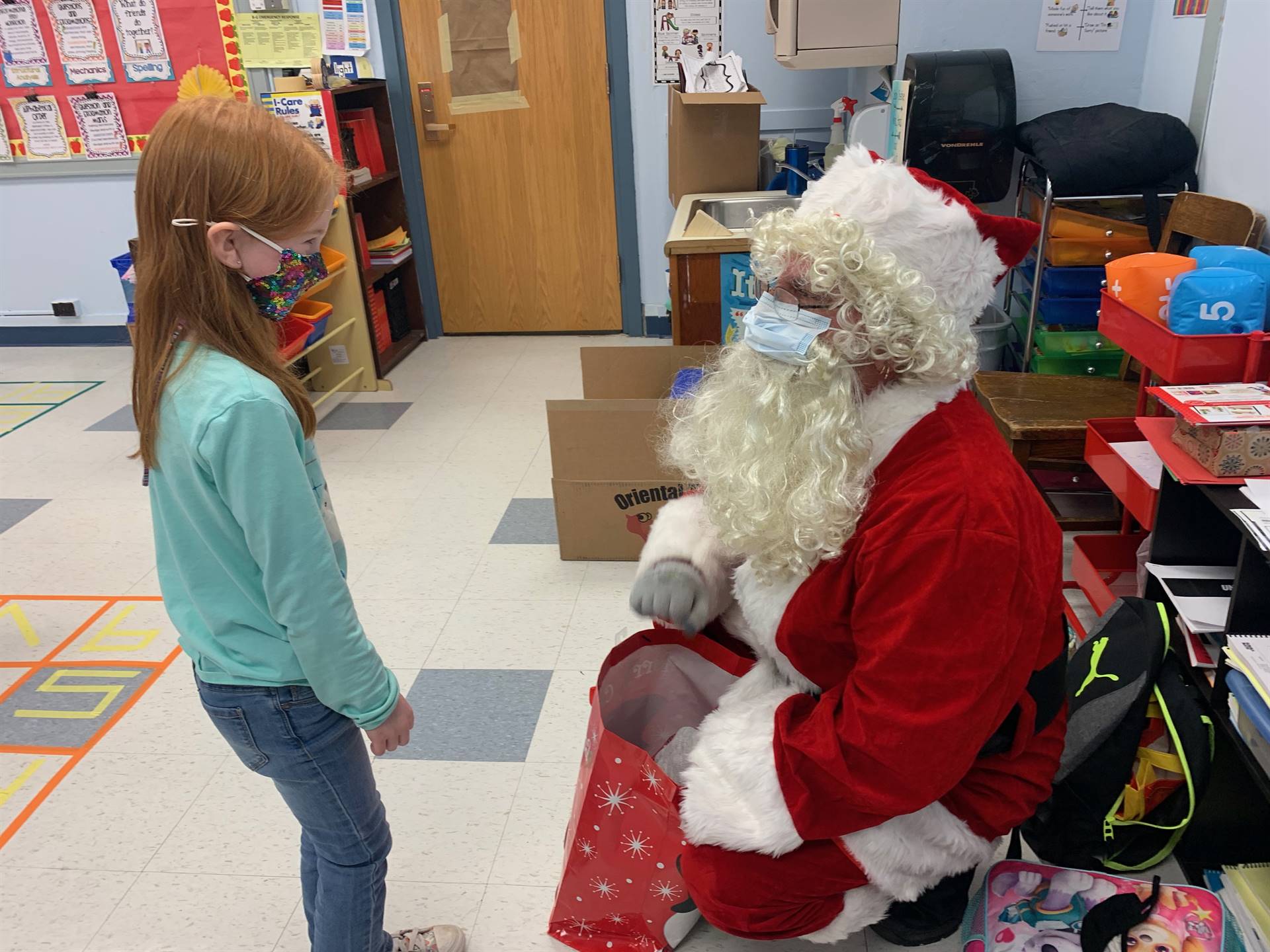 A student listens to Santa.