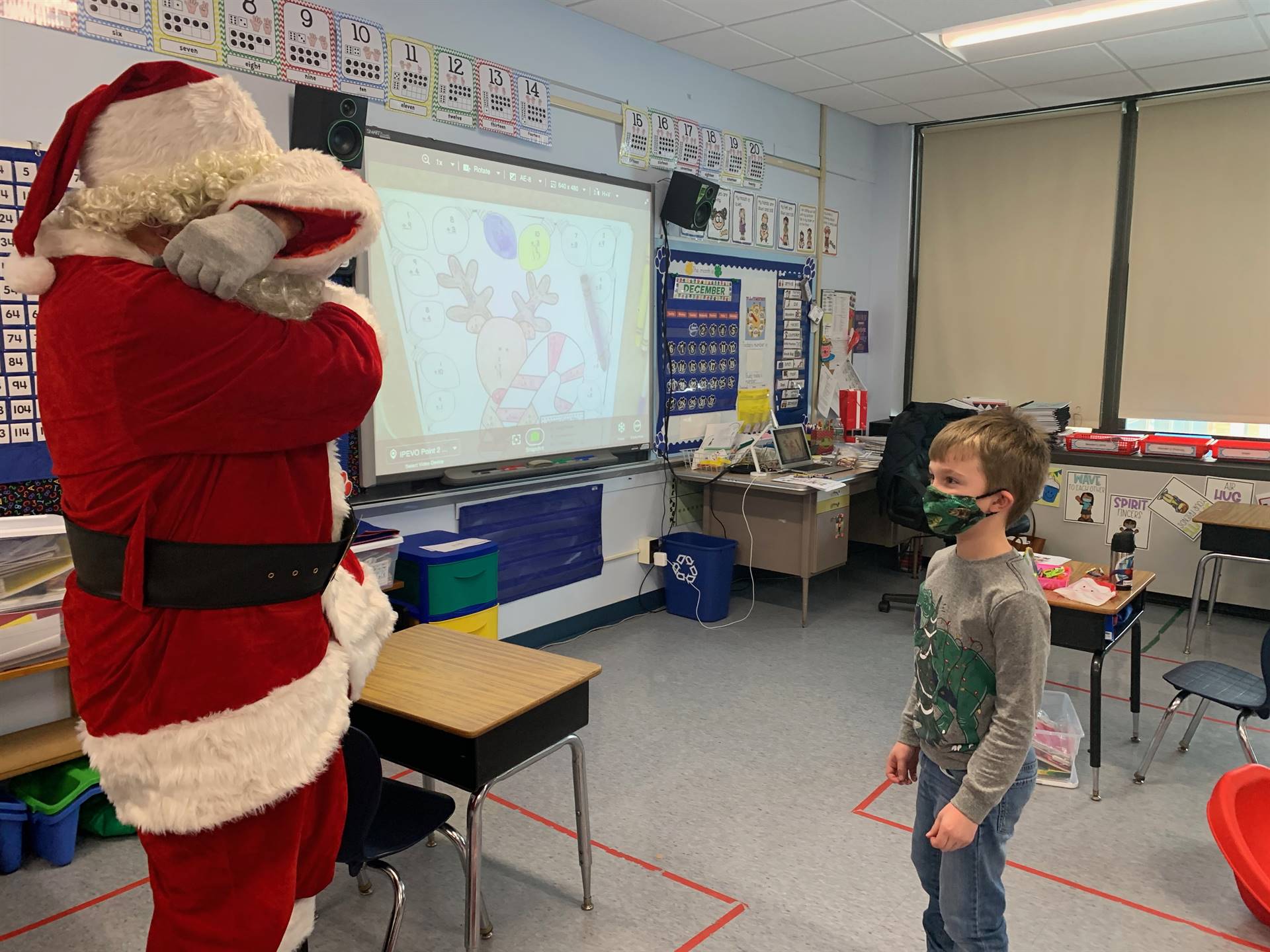 Santa shows how a dinosaur speaks. 