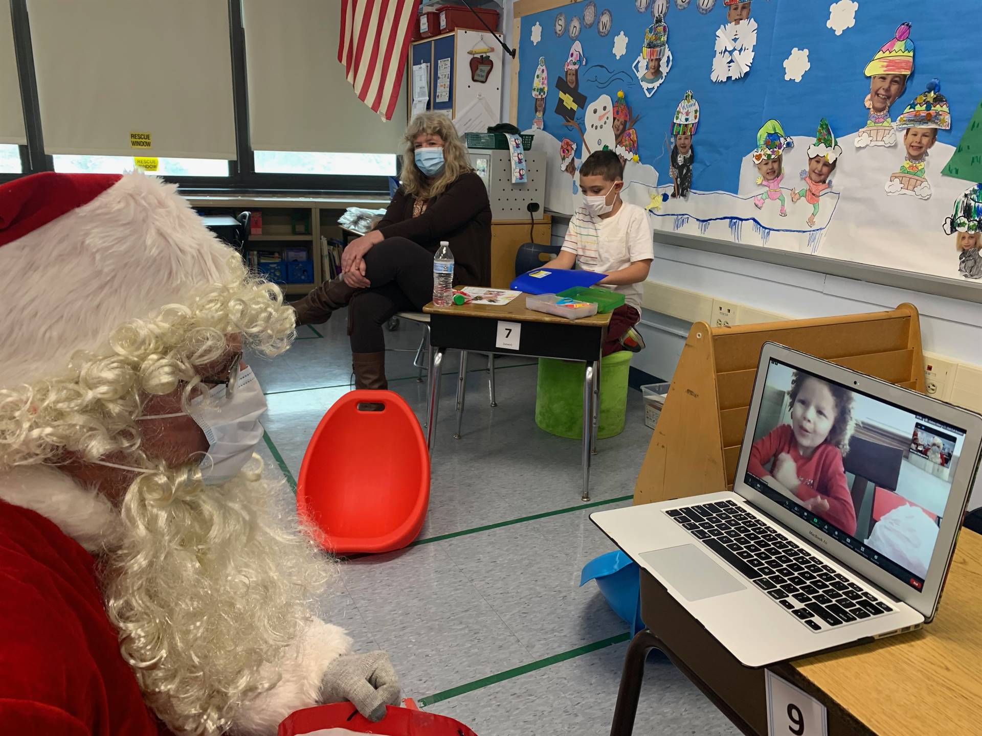 Santa zooms with a  student.