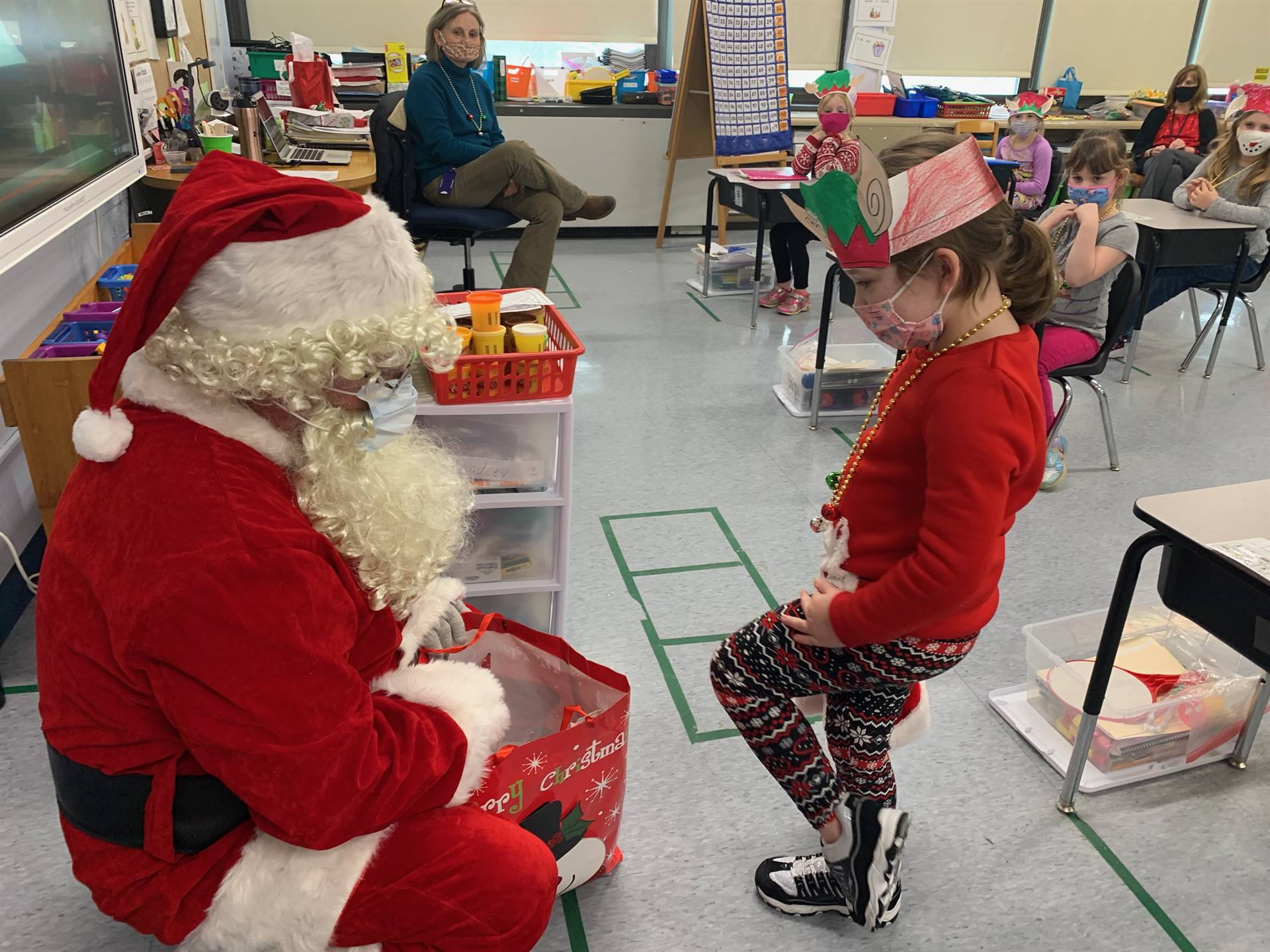 A student accepts a gift from Santa.