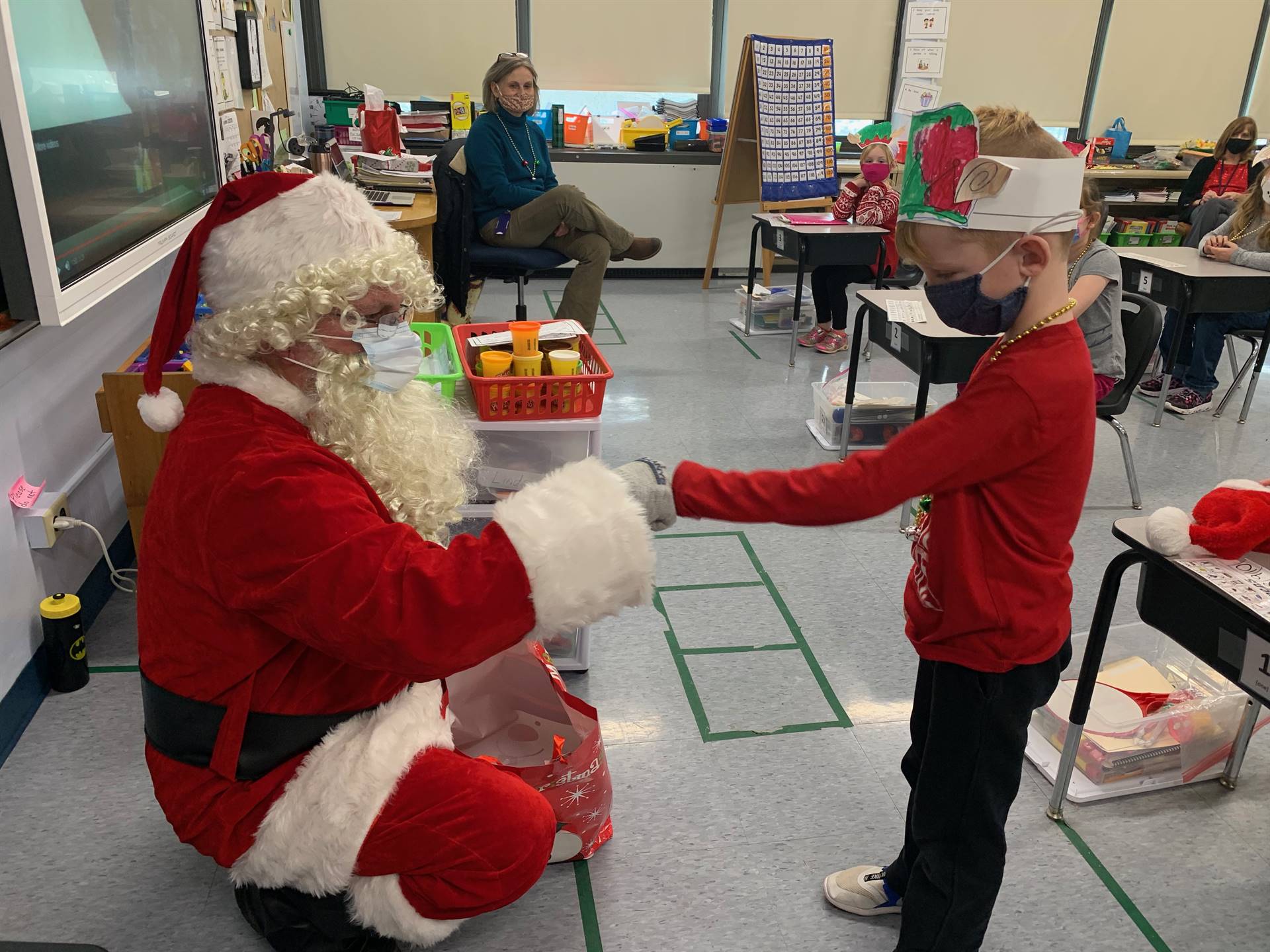 A student accepts a gift from Santa.