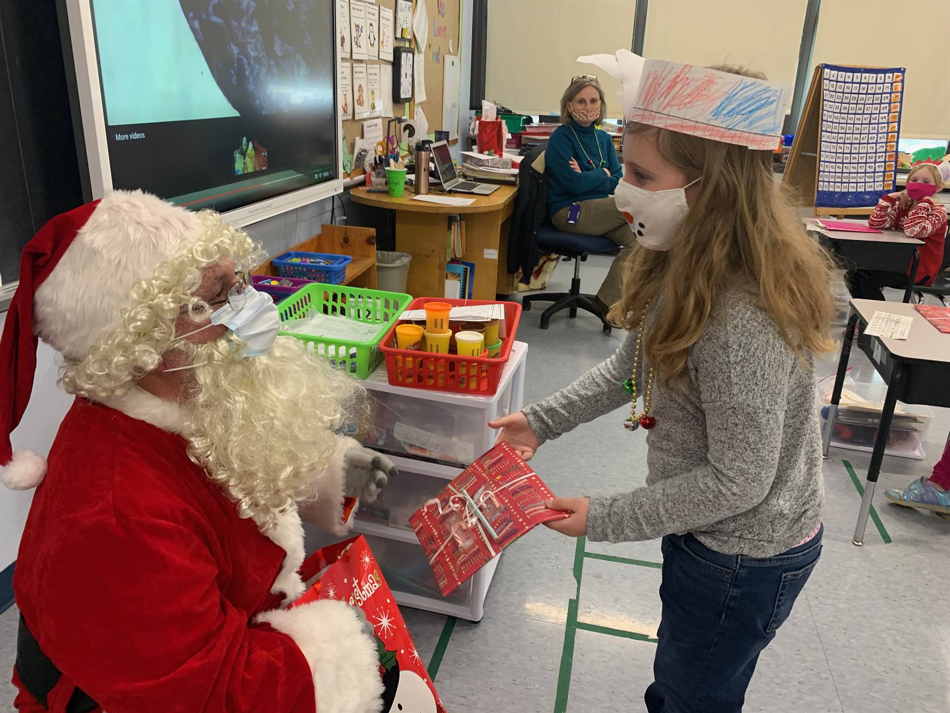 A student accepts a gift from Santa.