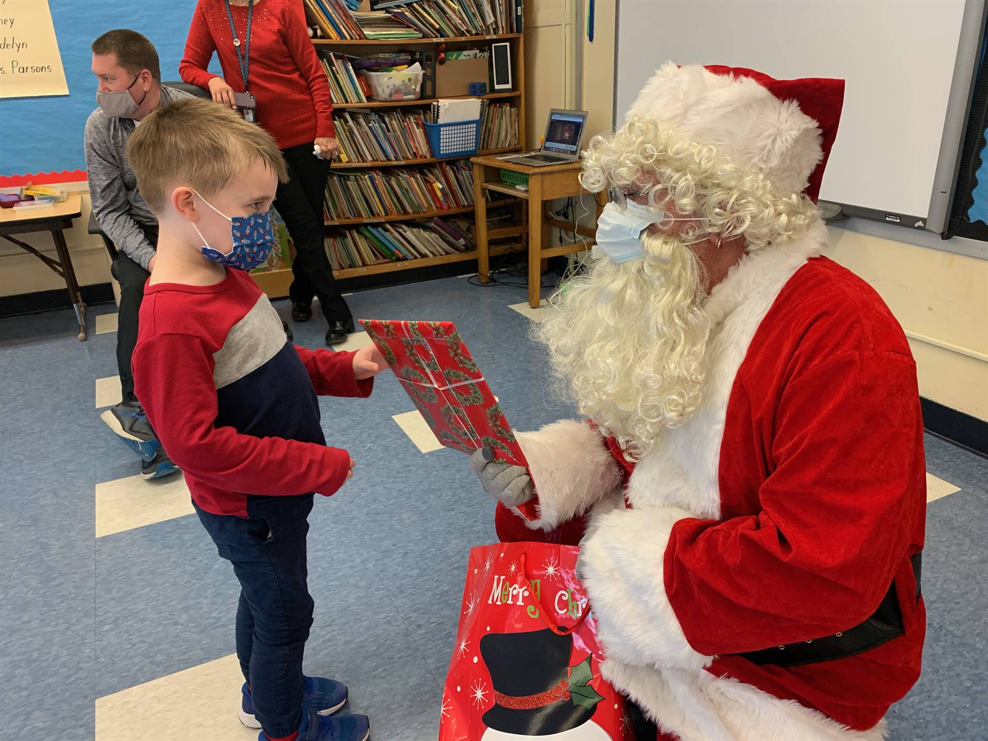 A student accepts a gift from Santa.