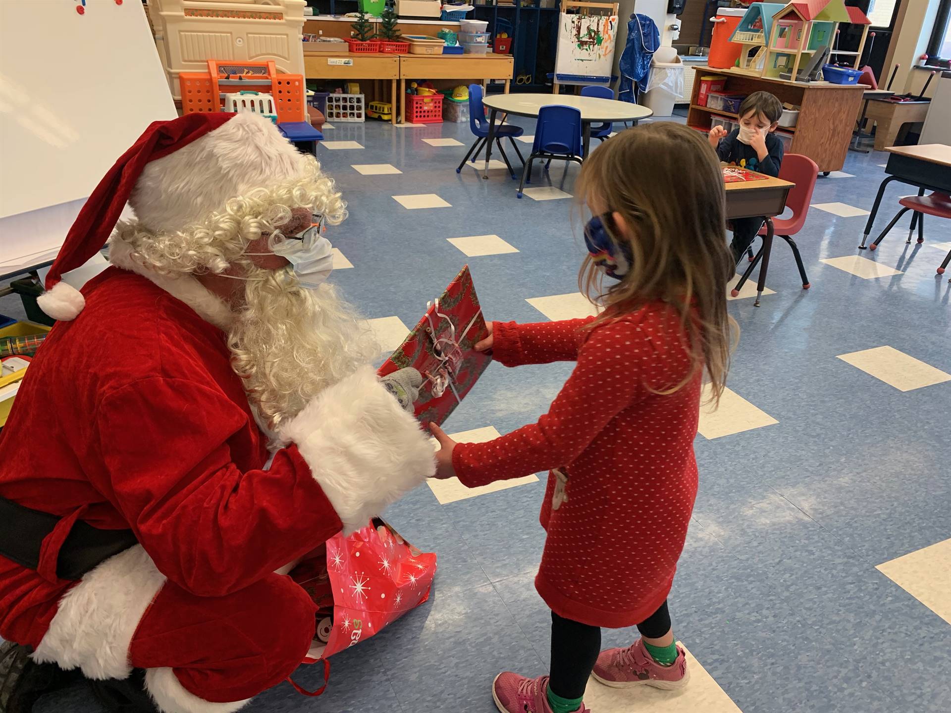 A student accepts a gift from Santa.