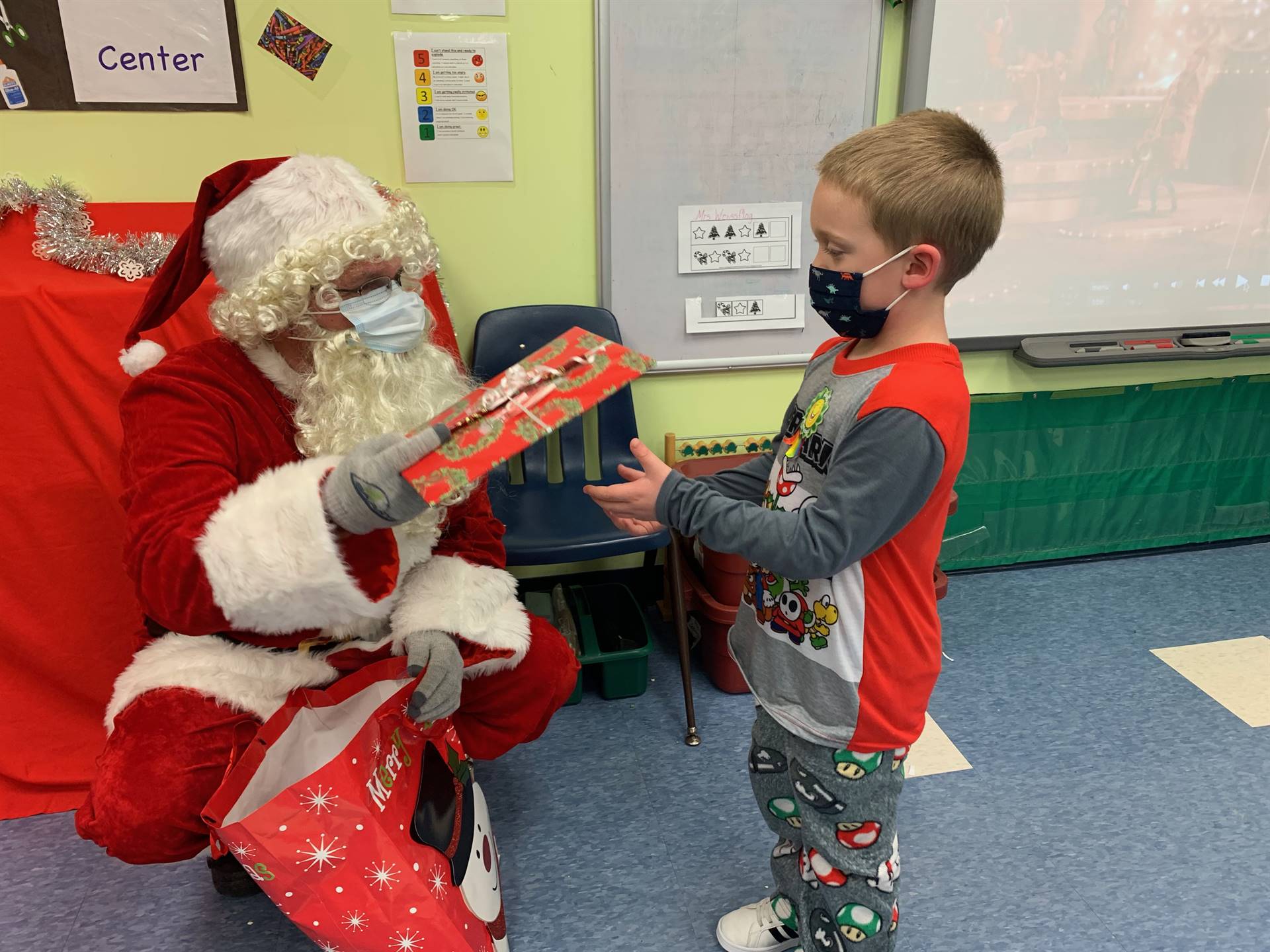 A student accepts a gift from Santa.