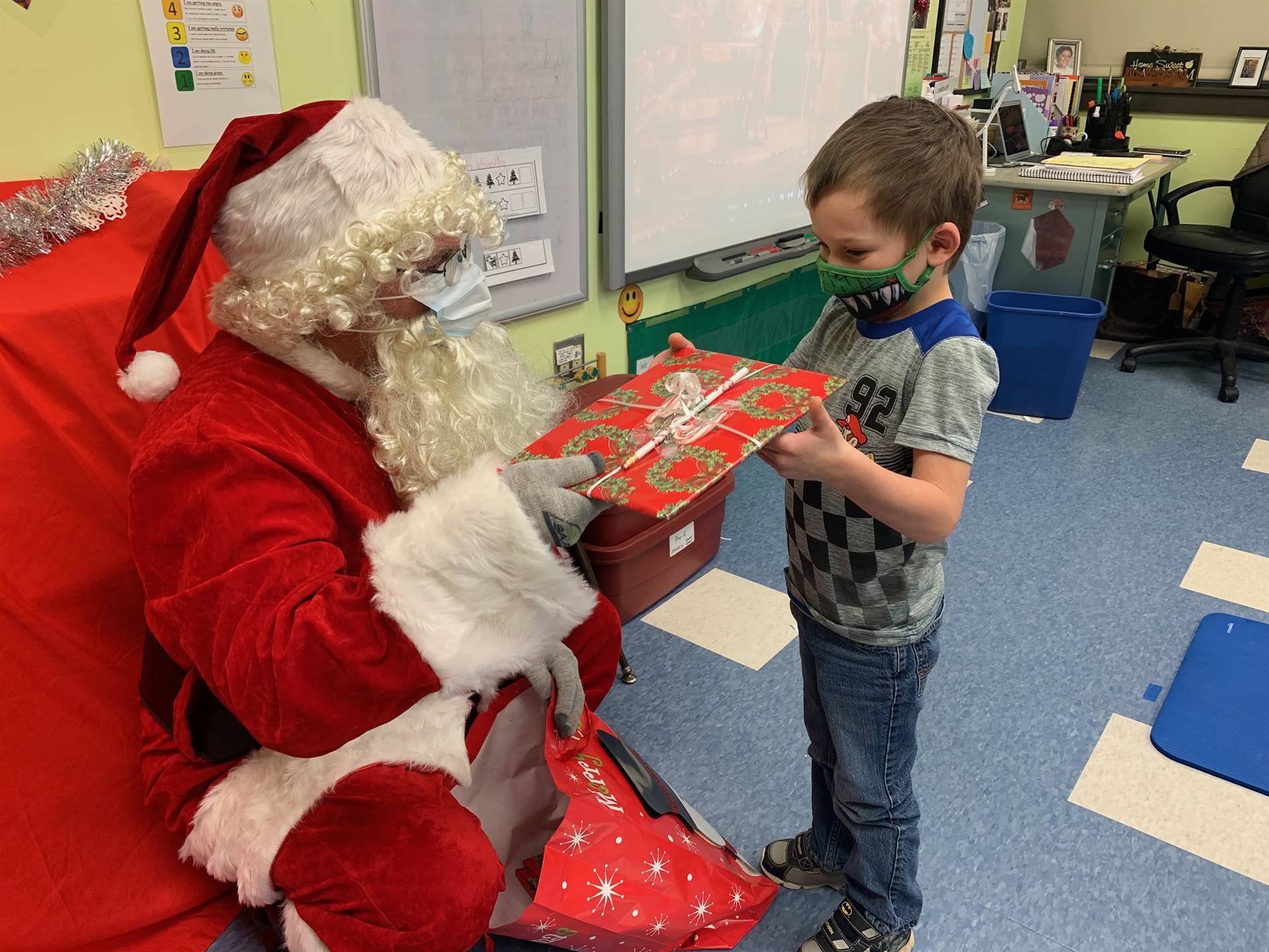 A student accepts a gift from Santa.