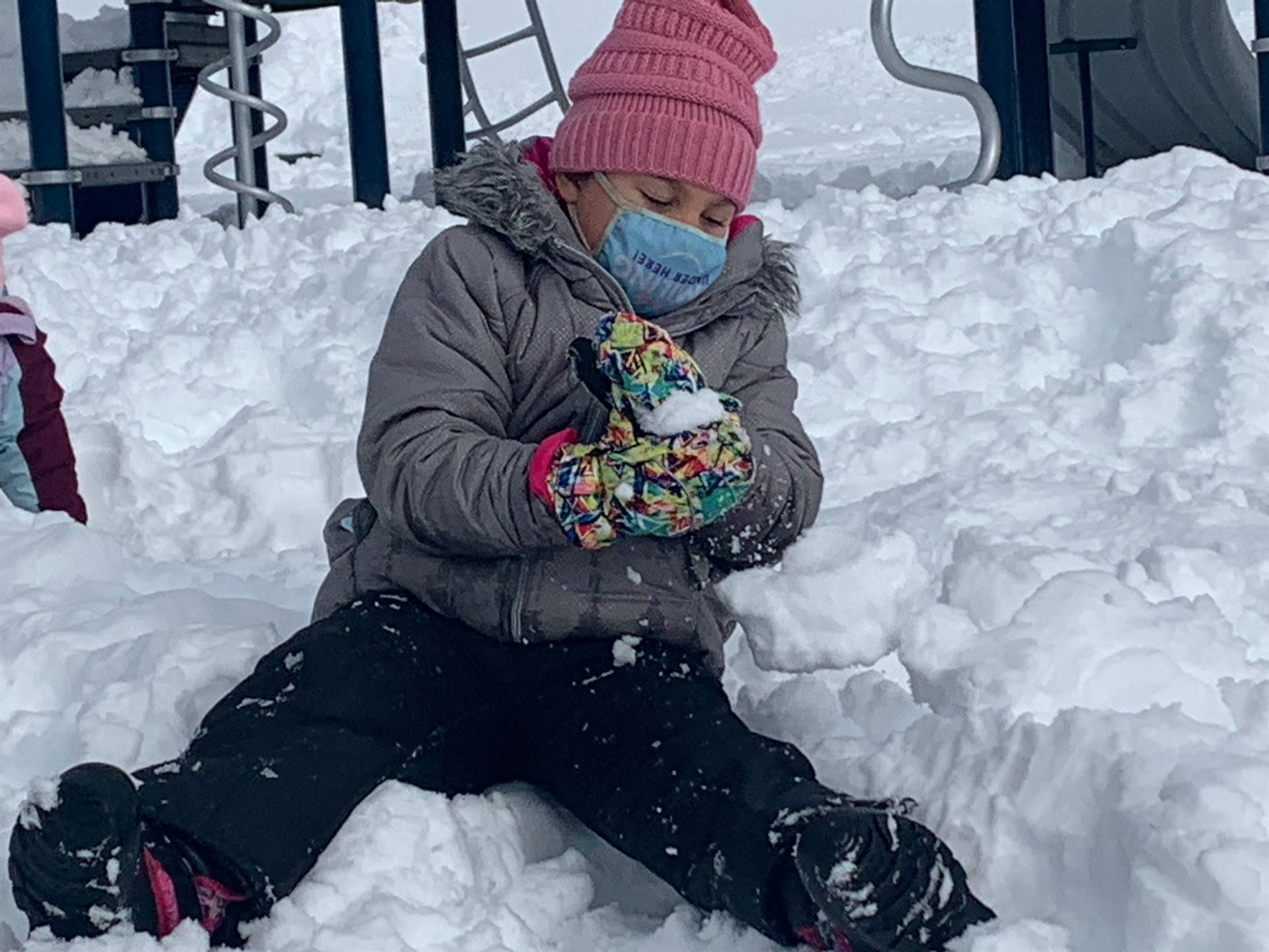 A student makes a snowball.