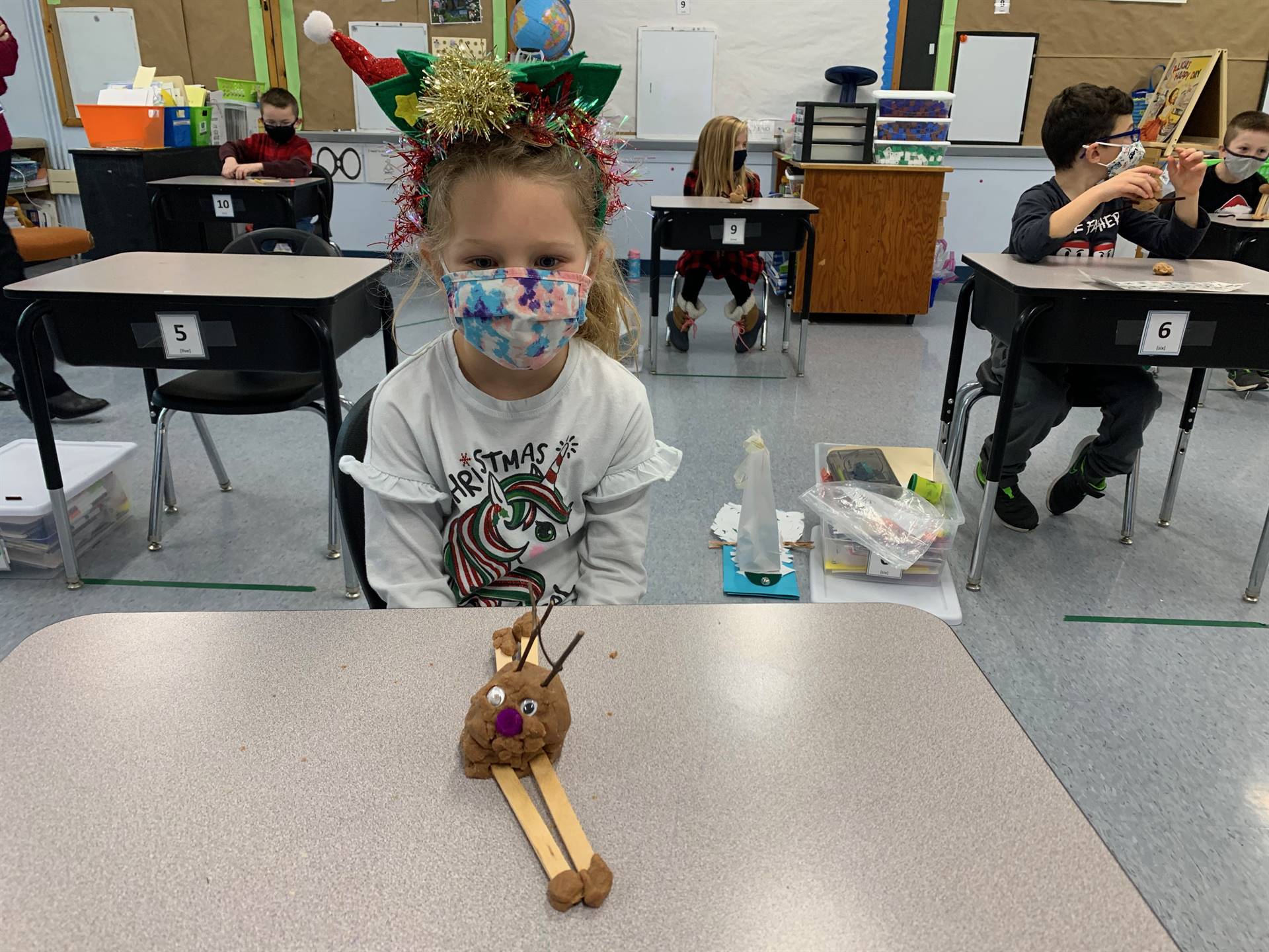 student shows playdo reindeer.