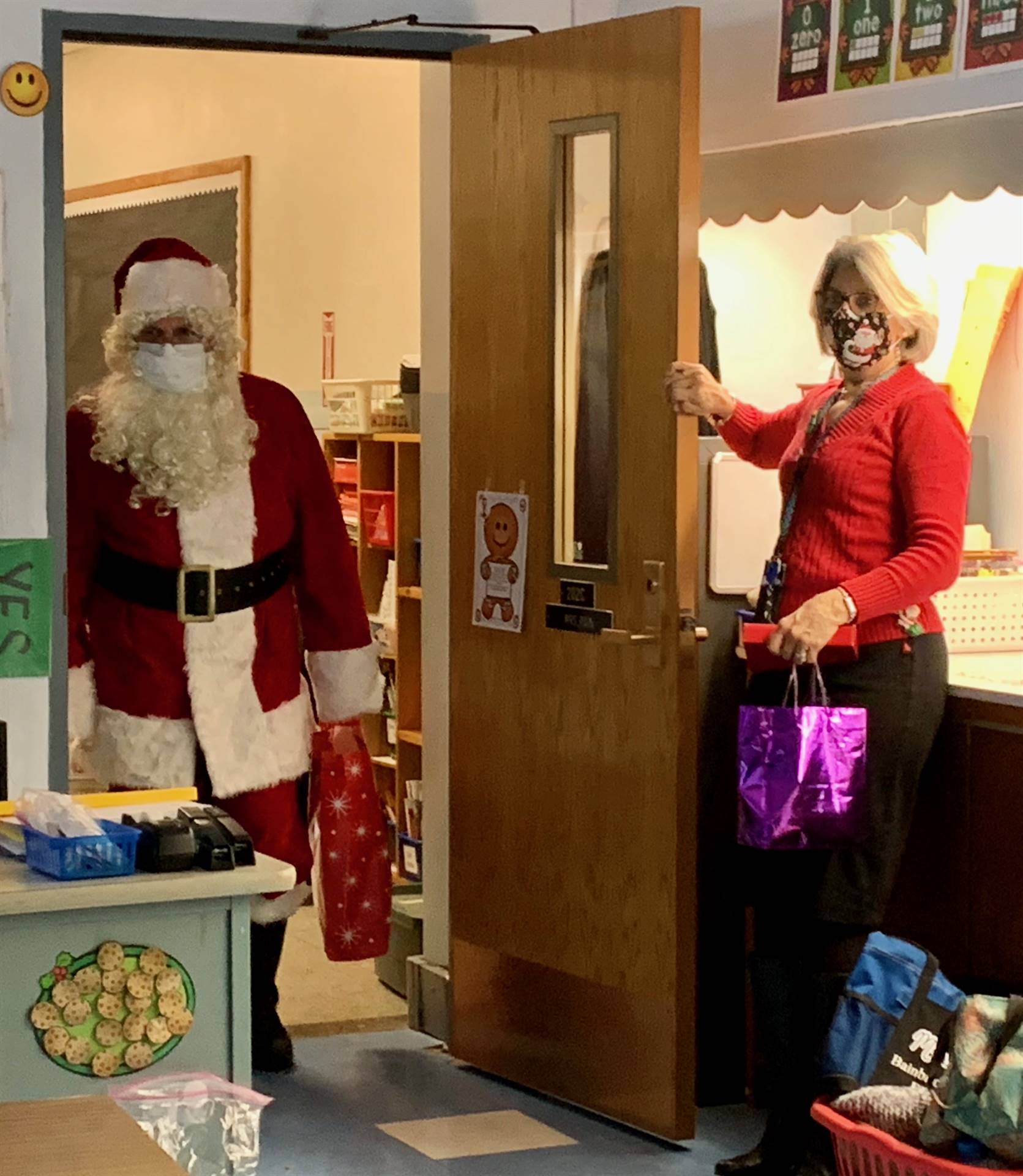 Santa and Mrs. Clause arrive through a classroom doorway!