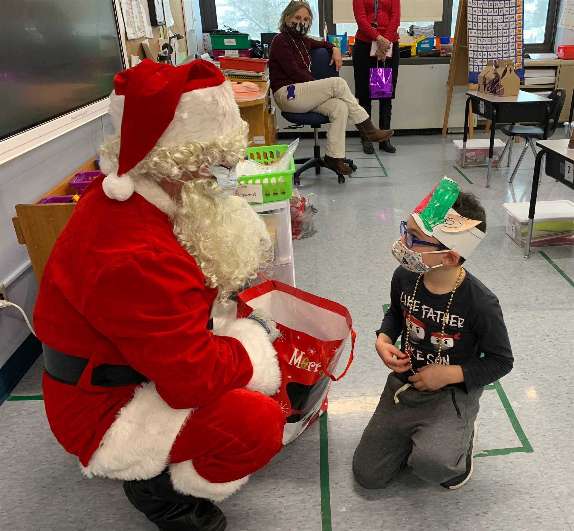 A student peers up at Santa.