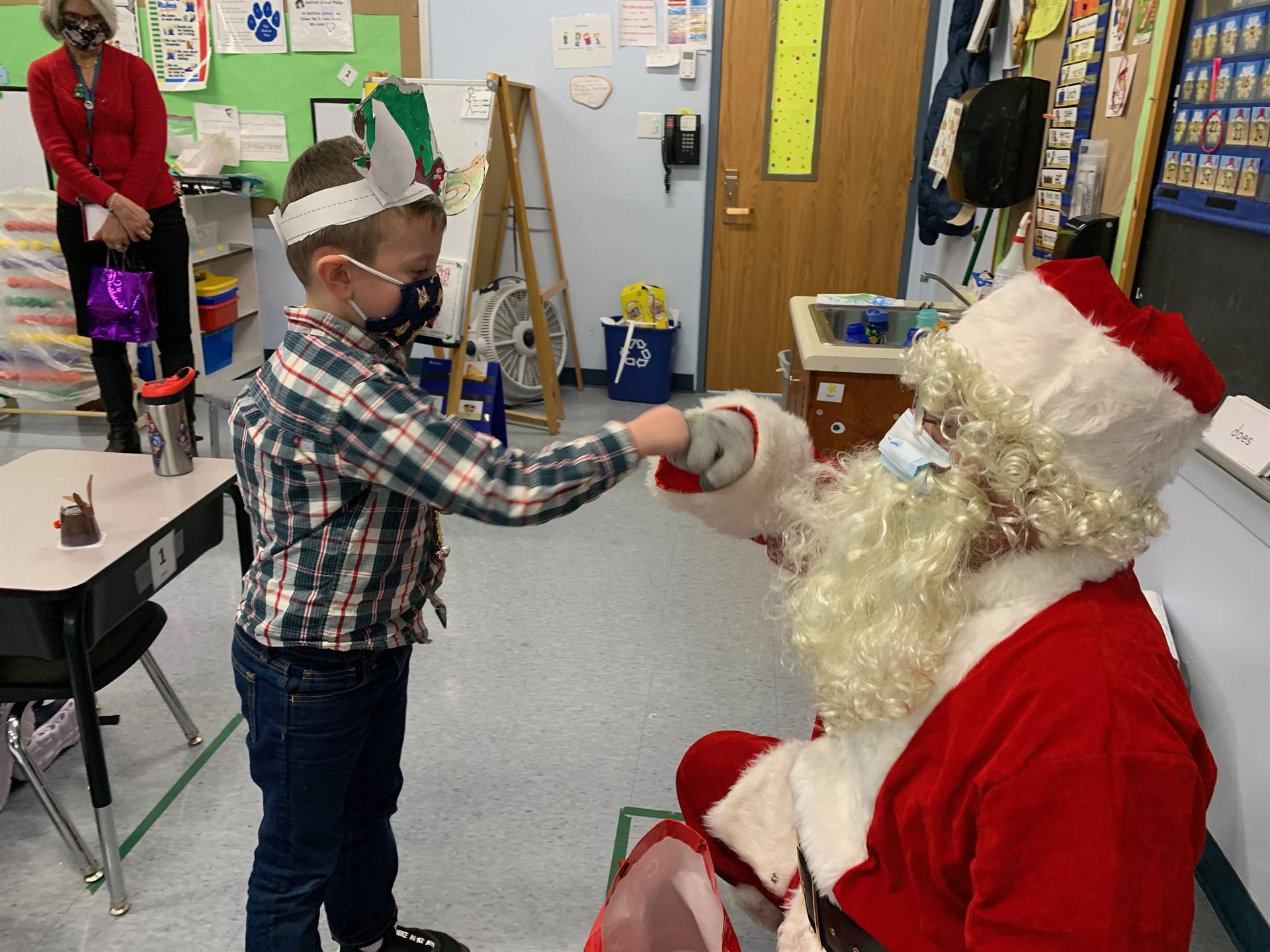 Santa gives his magical fist bump to a student.
