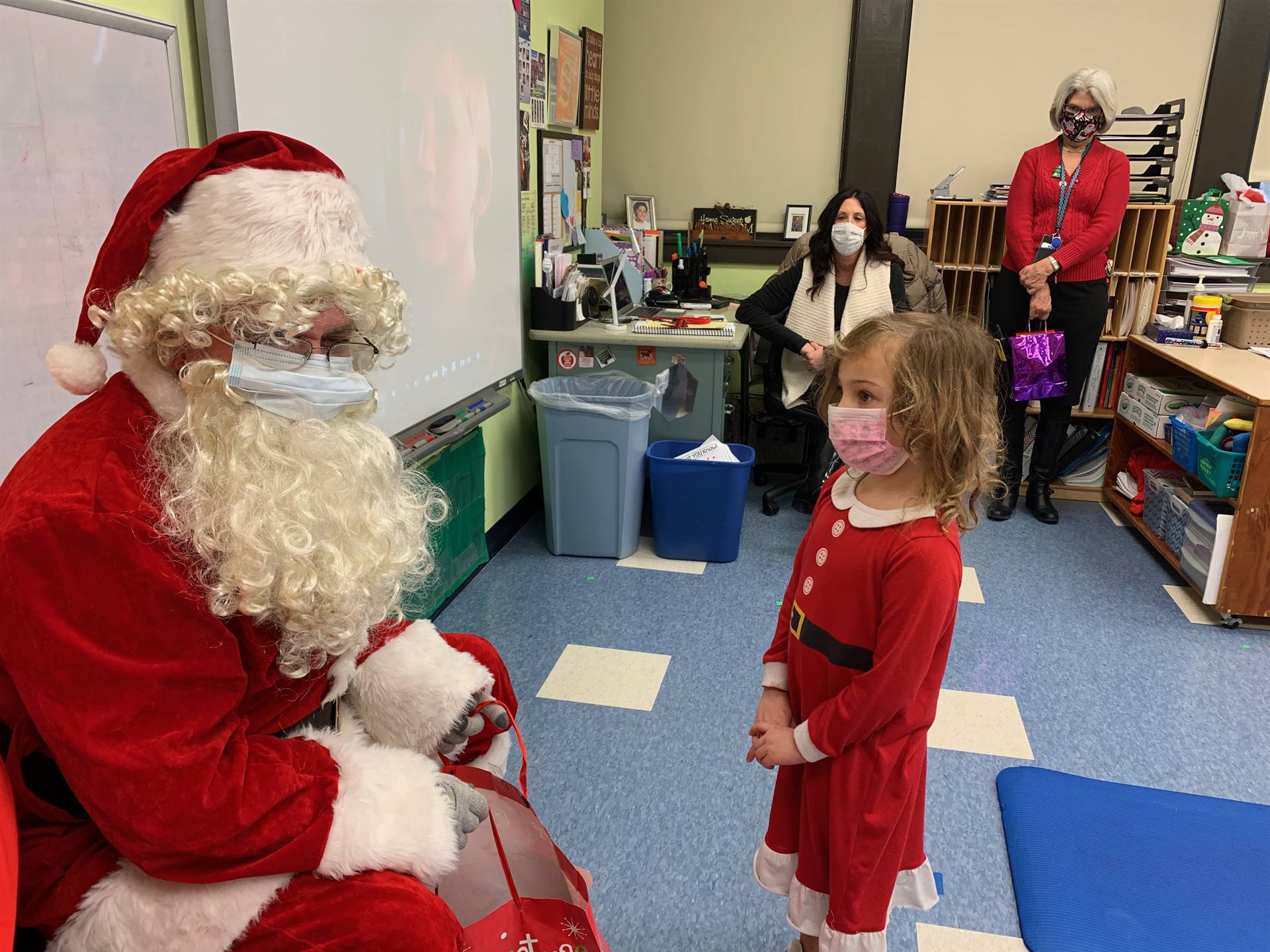 Santa loves that a student is dressed just like him.