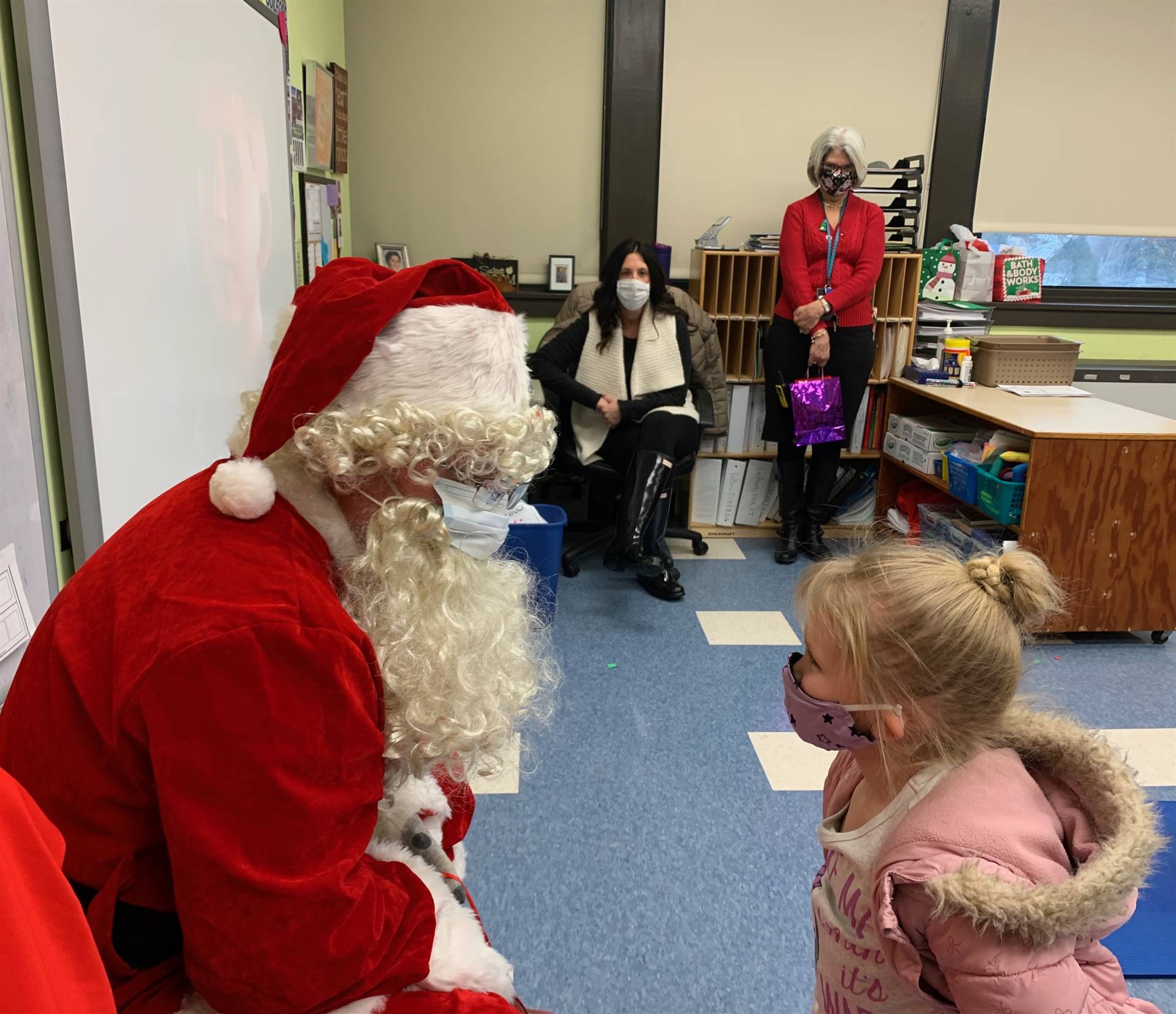 Santa and a student talk.