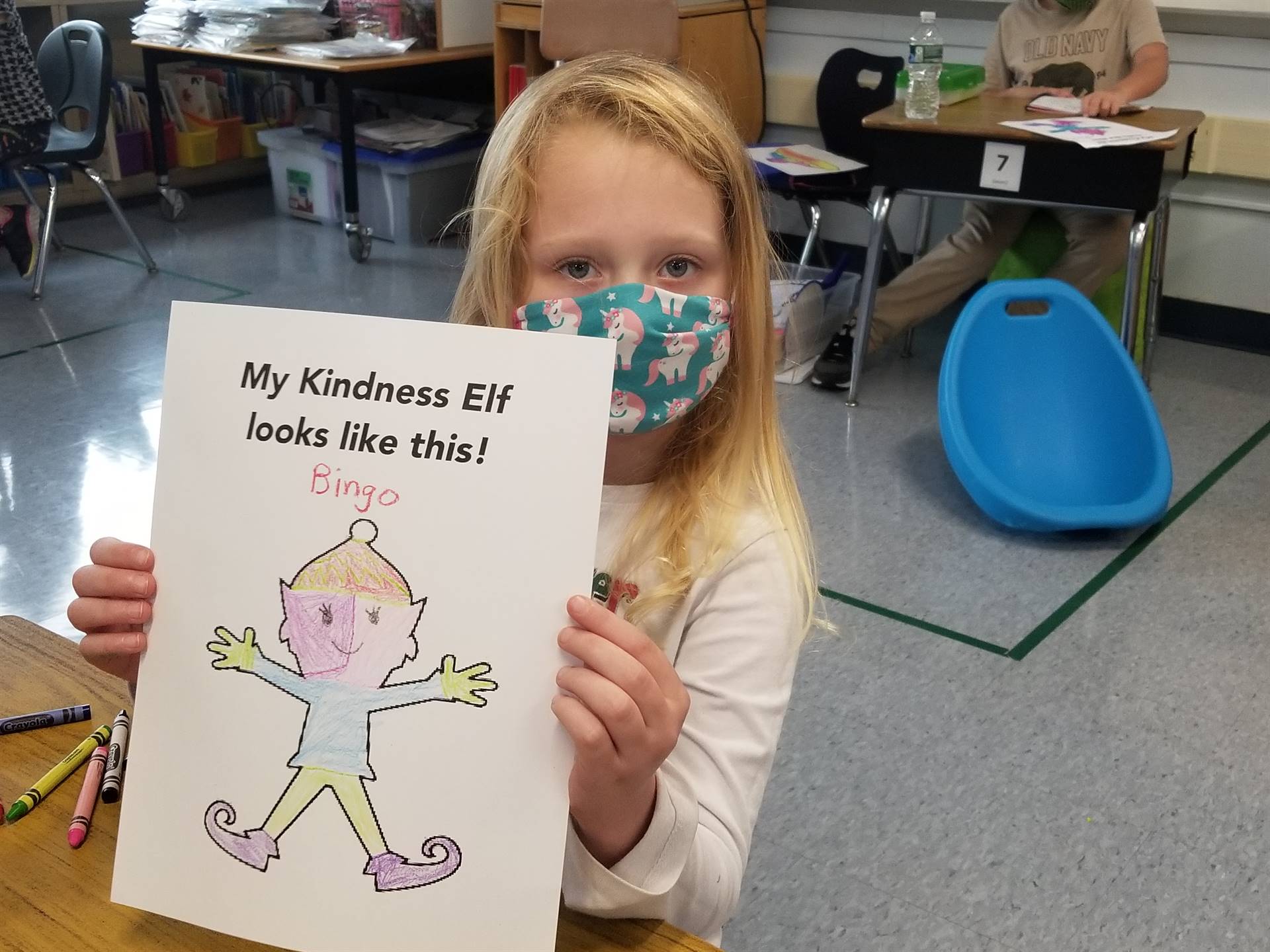 students shows a picture of the kindness elf