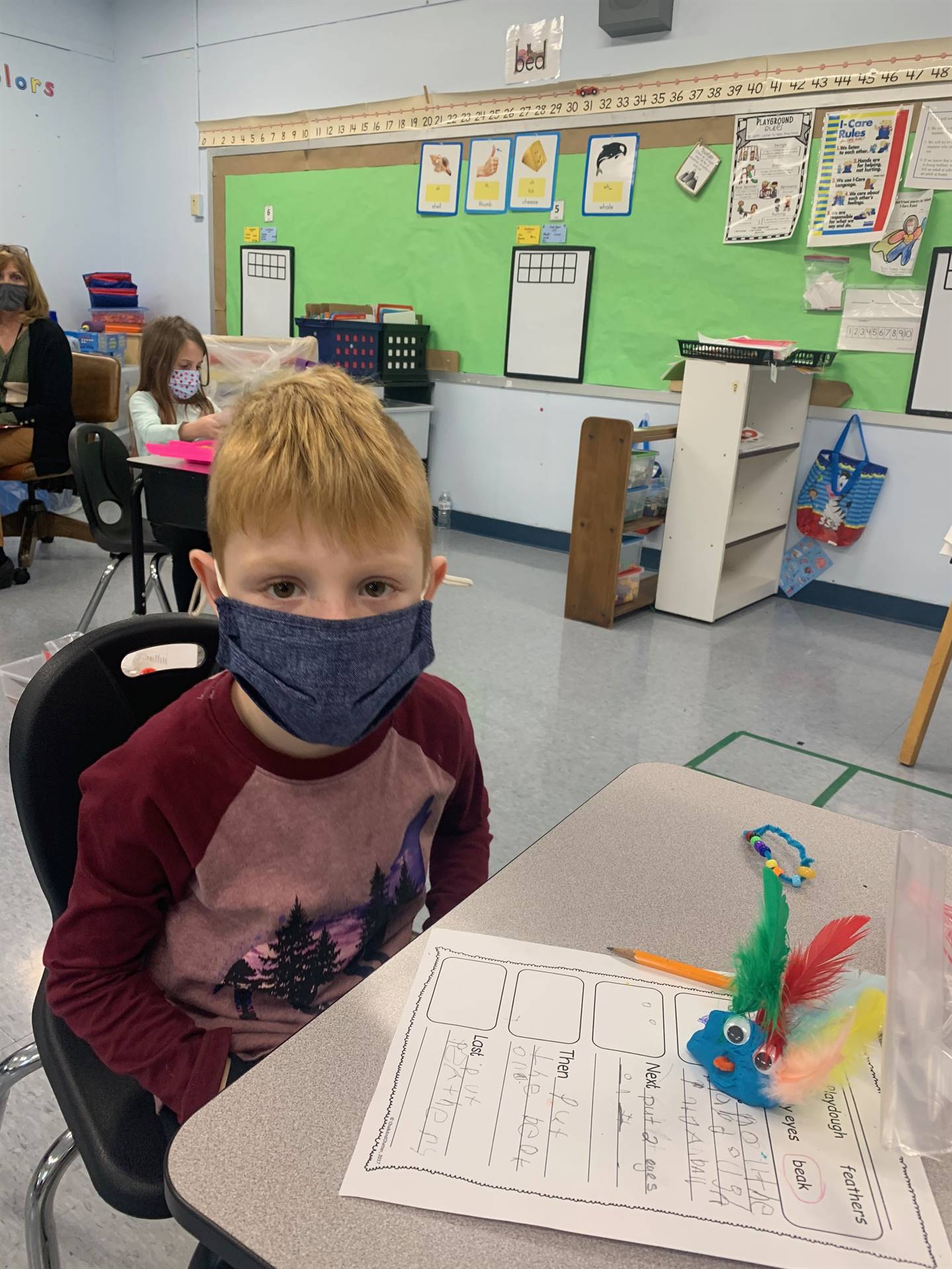 Student proudly displays writing and playdo turkey!