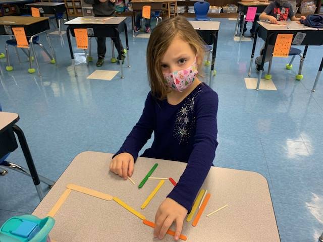 A student is building with sticks in math!