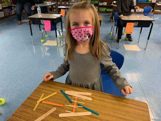 A student is building with sticks in math!