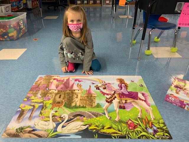 Student shows off a giant floor puzzle! 