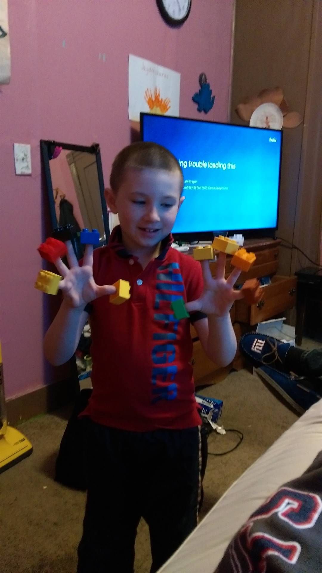 student with legos on his hand