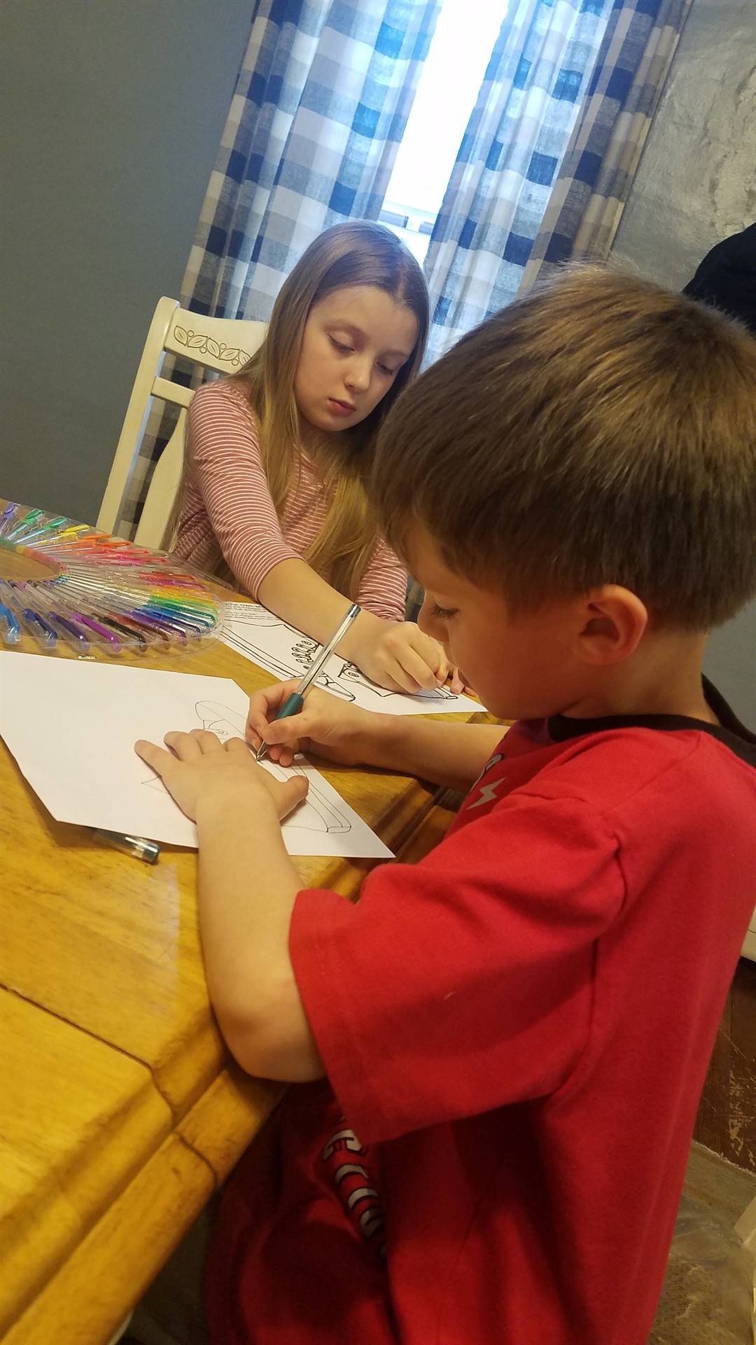 2 students working at table. 