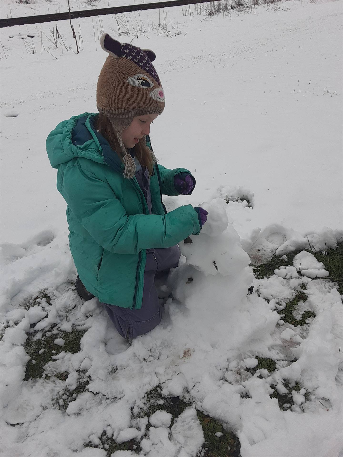 Student building snowman.